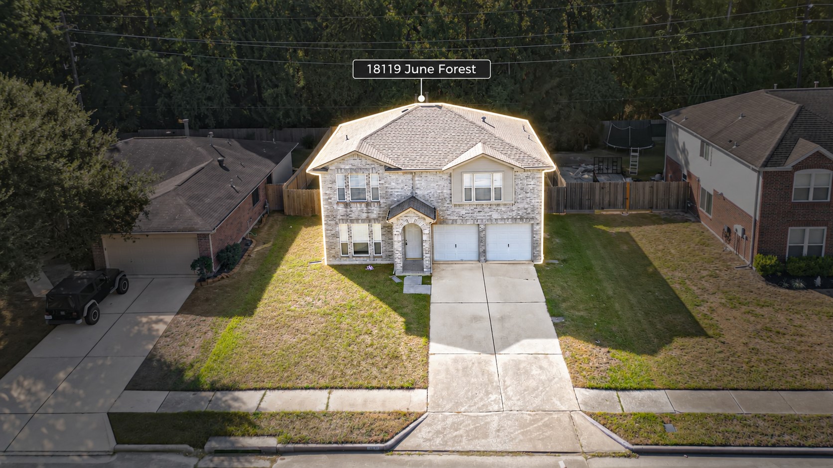 Spacious driveway with ample parking space for multiple vehicles.