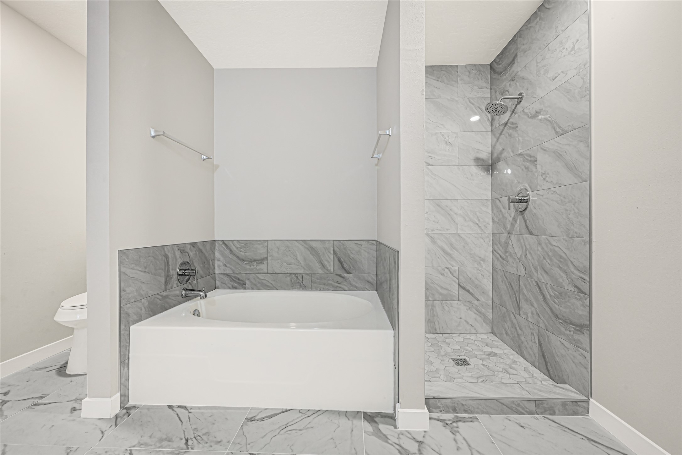 Soaking tub positioned alongside a tiled walk-in shower, creating a serene, spa-like retreat perfect for unwinding after a long day.