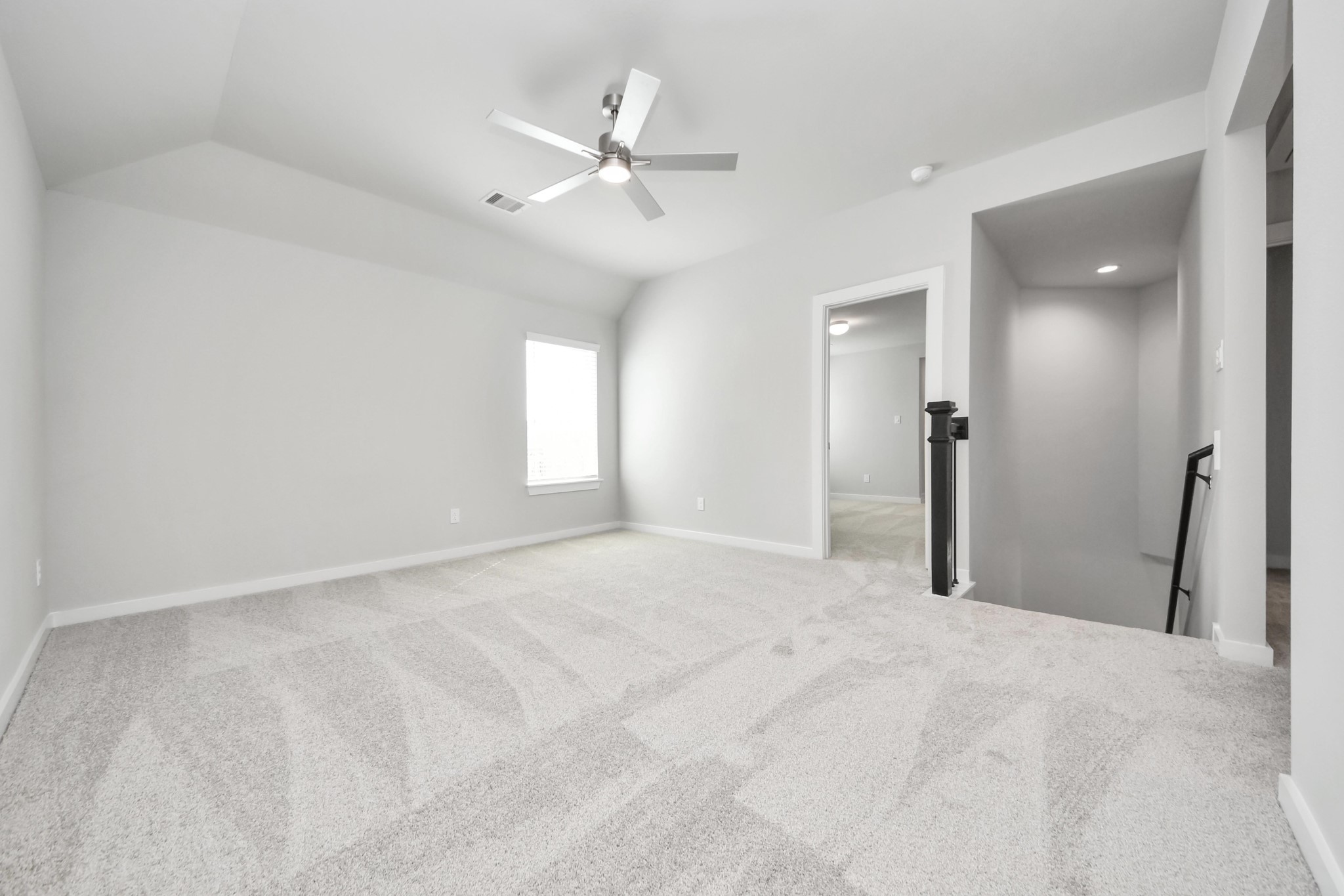 Ascend to relaxation in this fantastic game room! Ideal for both casual gatherings and adult gaming, it boasts plush carpet, lofty ceilings, custom paint, and ample windows for abundant natural light. Sample photo of completed home with similar floor plan. Actual colors and selections may vary.