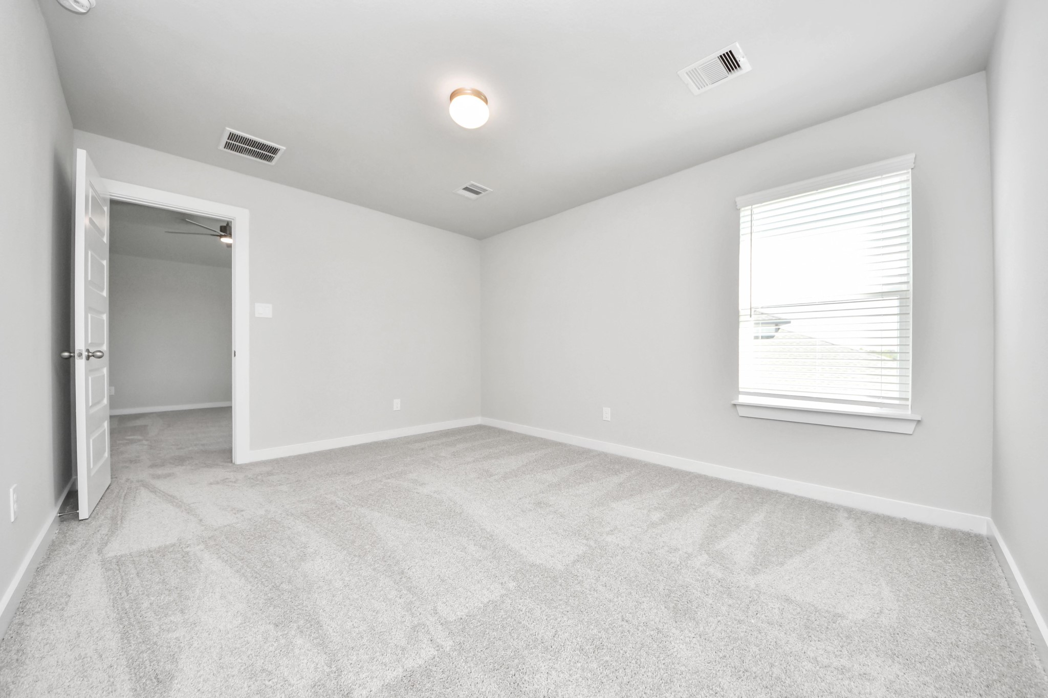 Generously sized secondary bedrooms featuring spacious closets, soft and inviting carpeting underfoot, large windows allowing plenty of natural light, and the added touch of privacy blinds for your personal retreat. Sample photo of completed home with similar floor plan. Actual colors and selections may vary.