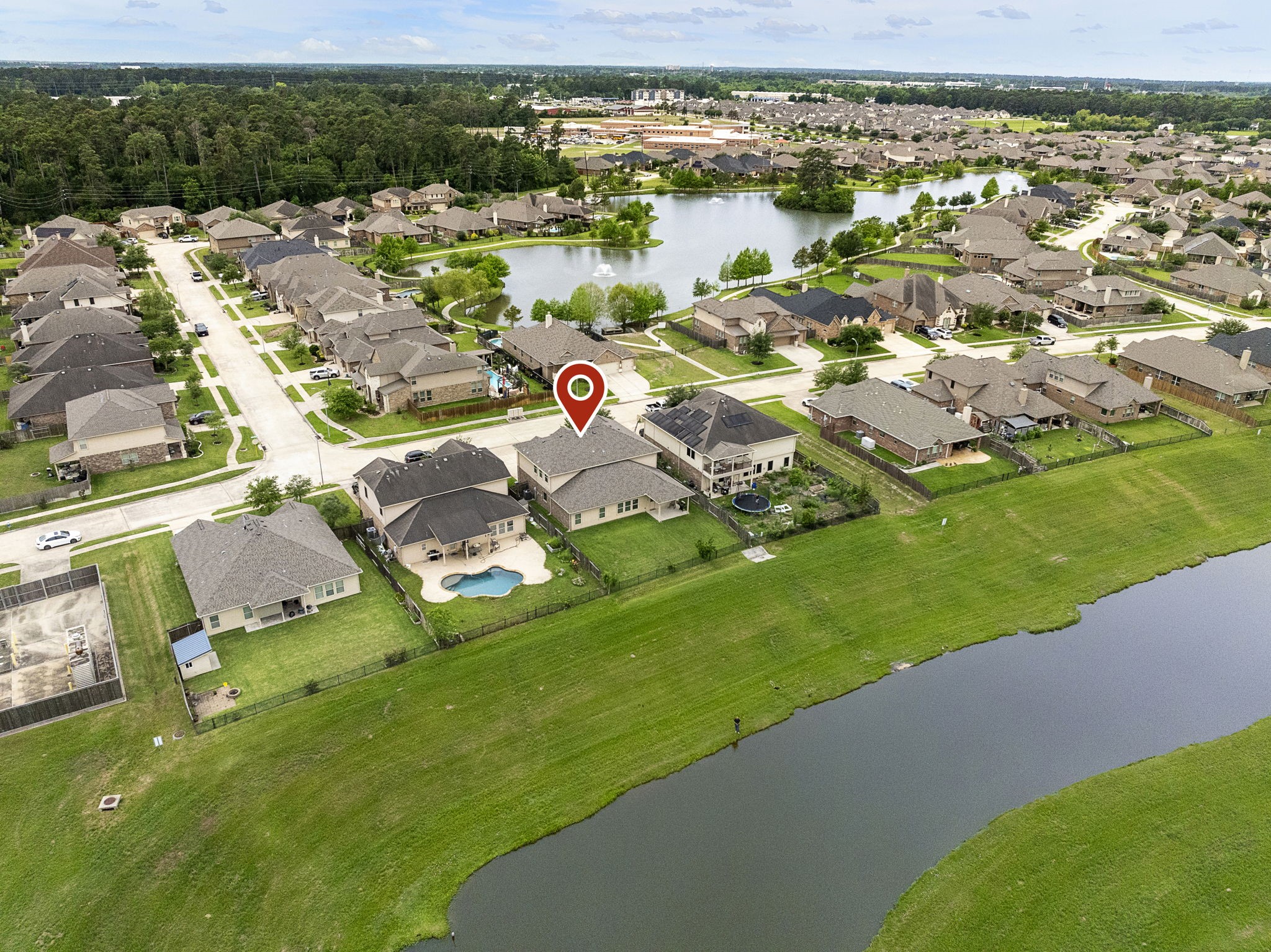 This home privately backs to the water with a thick greenspace barrier in between! Also note the large lake just across the street in front of the house. Unbelievable nature opportunities right at your front AND back doors!