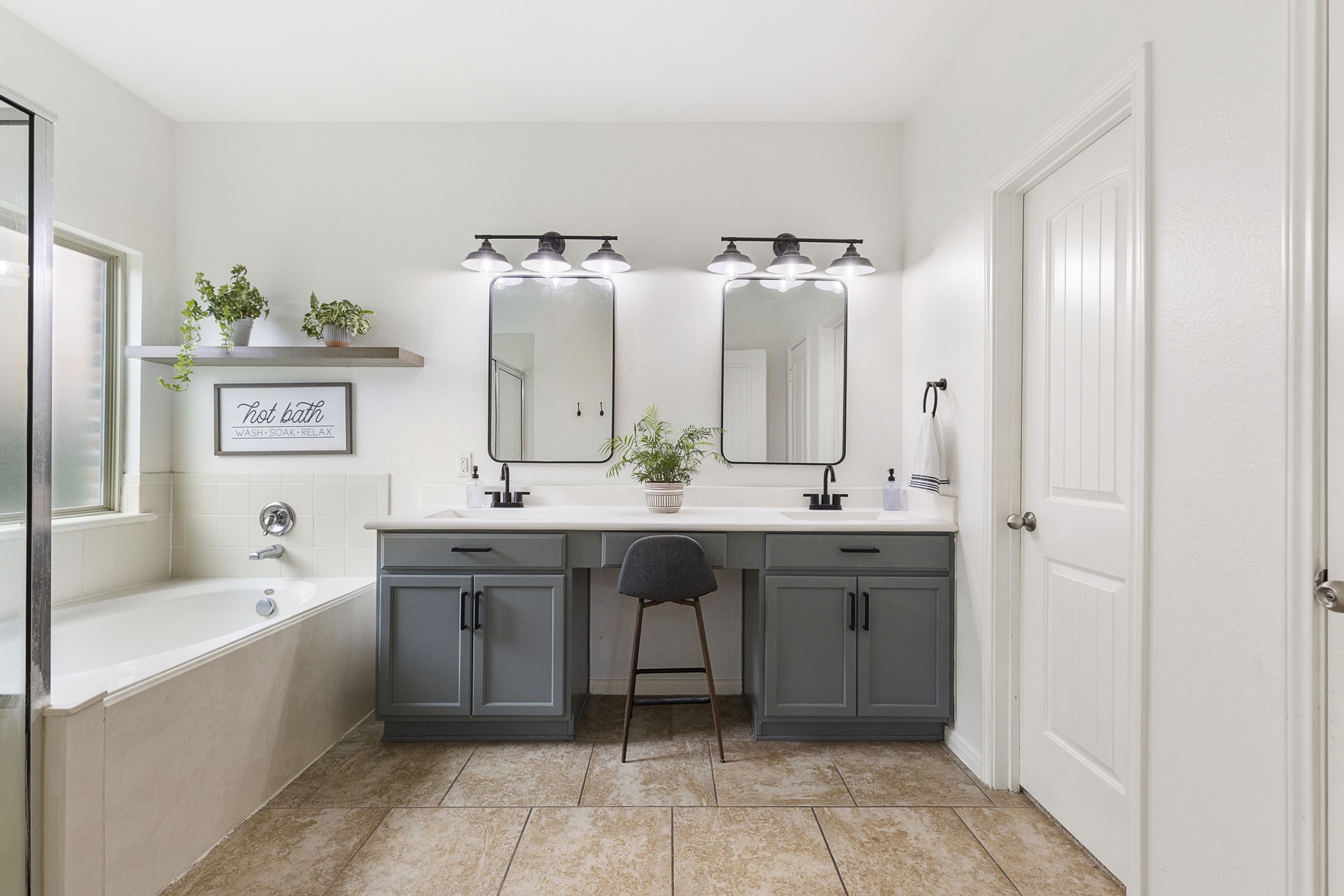 Primary bathroom with double sinks and a huge walk-in closet.