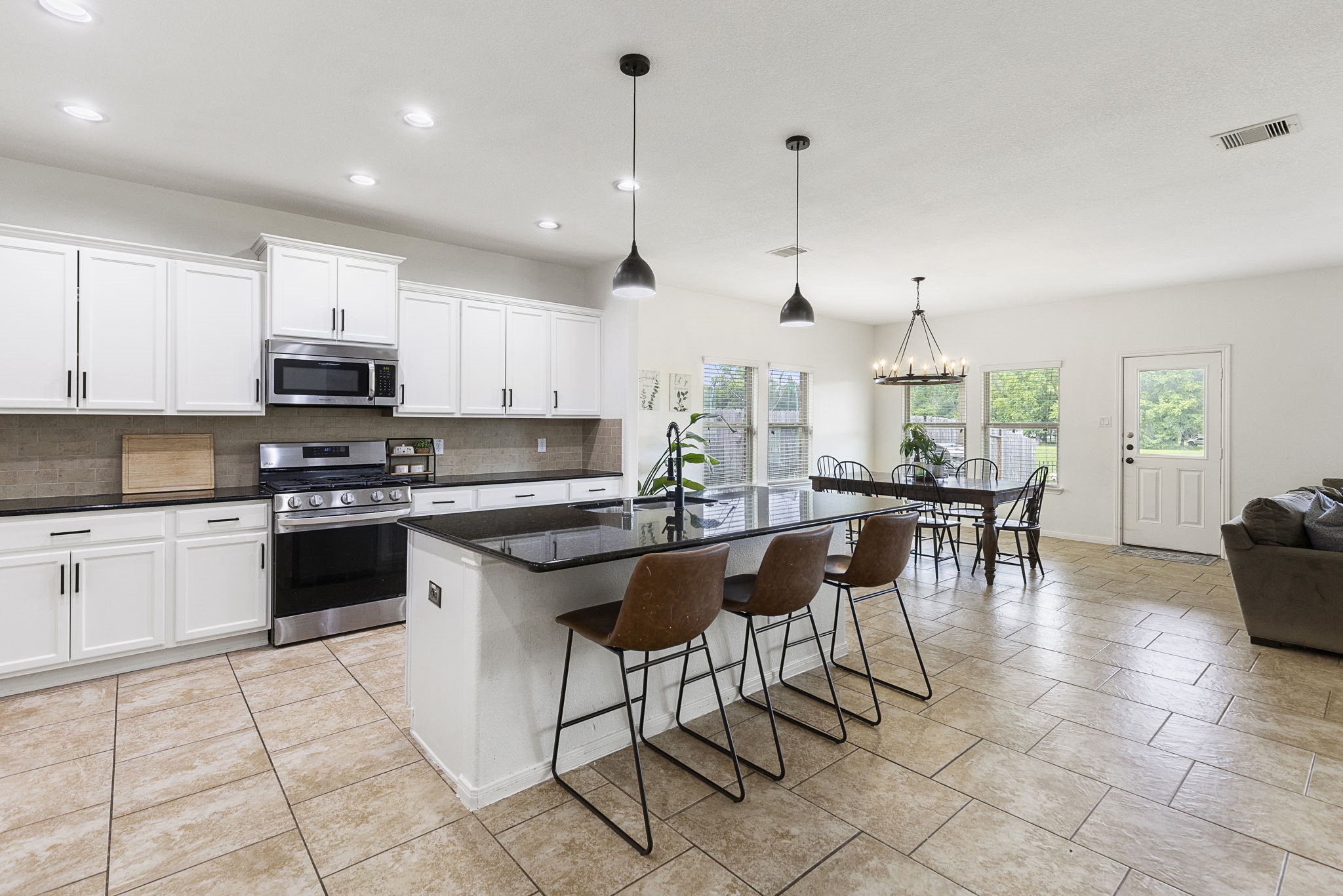 The walls of windows overlooking the backyard provide tons of natural light in this open space.