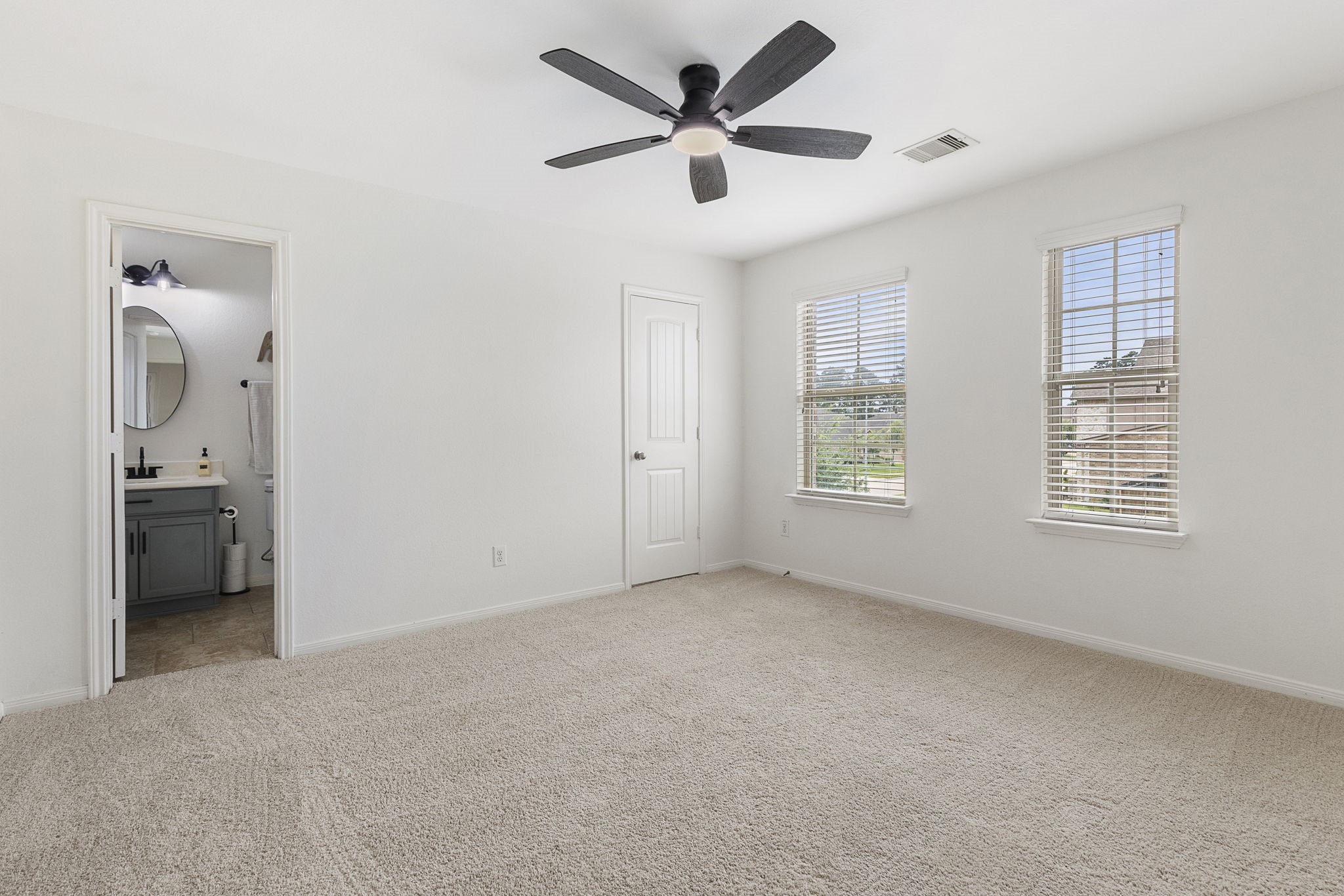One of four additional bedrooms upstairs. This one has a private ensuite bathroom.