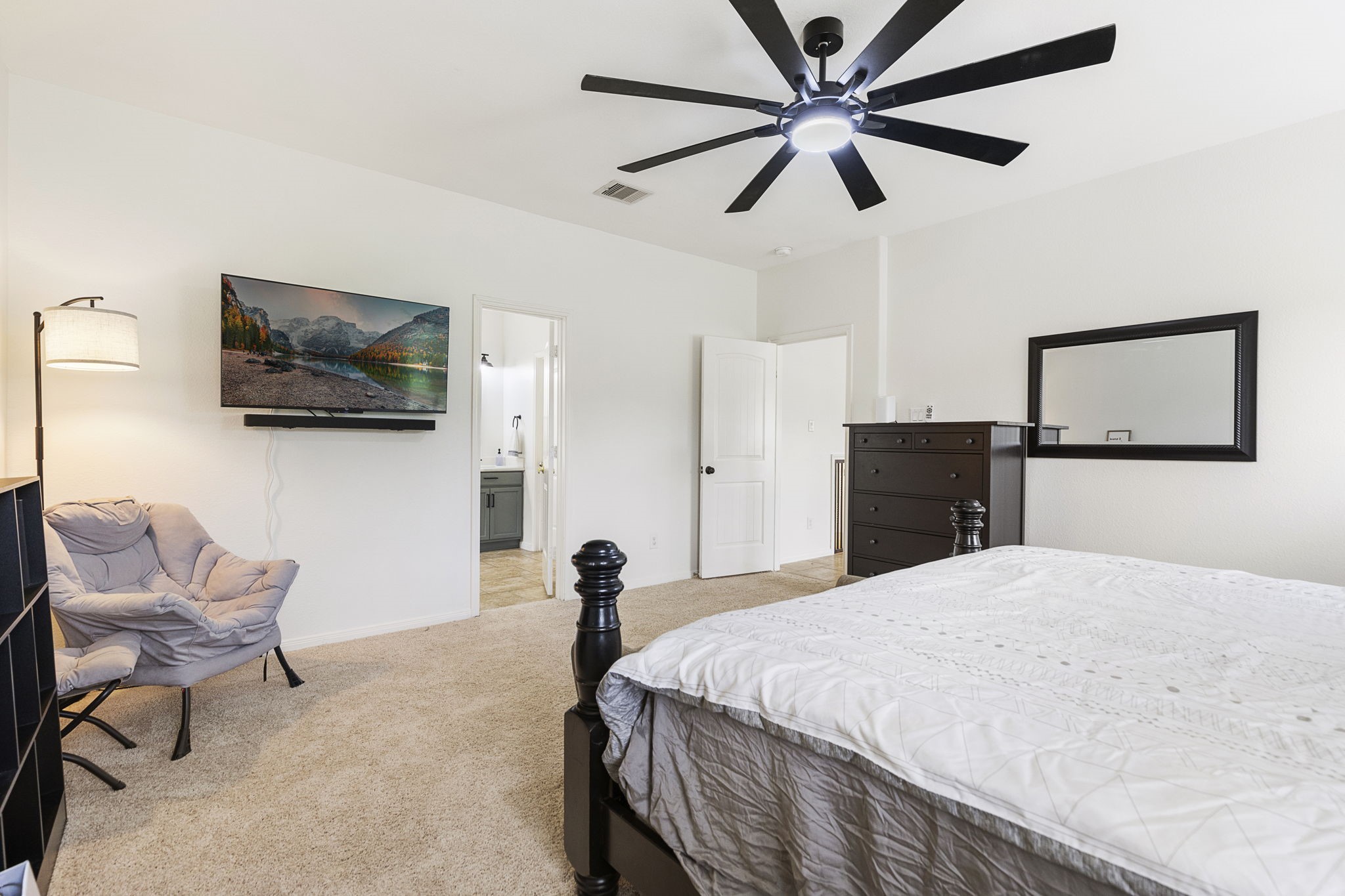 The primary suite is large enough for multiple pieces of furniture and still room to move around.