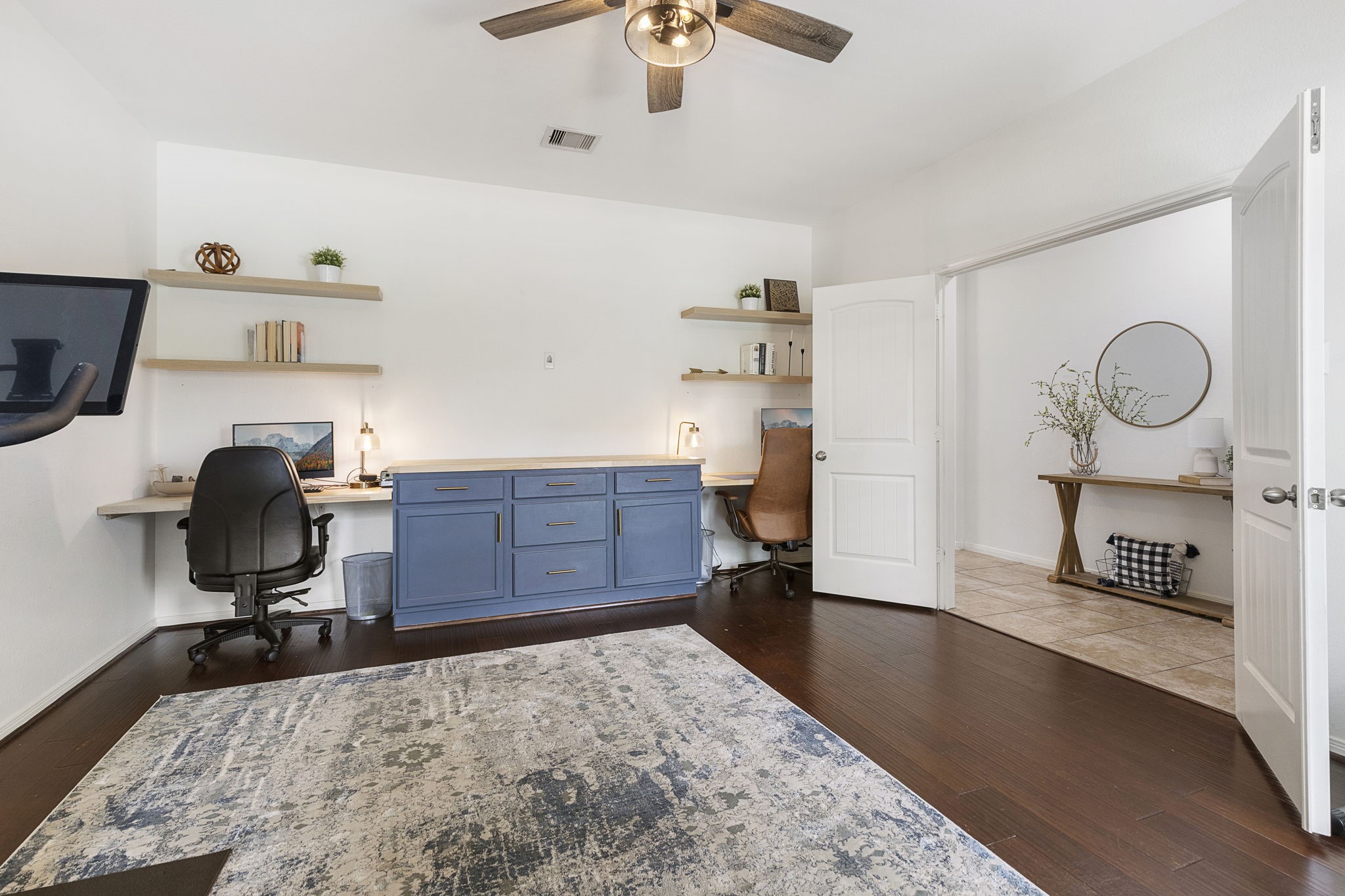 Seller has upgraded the study to feature this dual desk built-in with center worktop and enclosed storage.