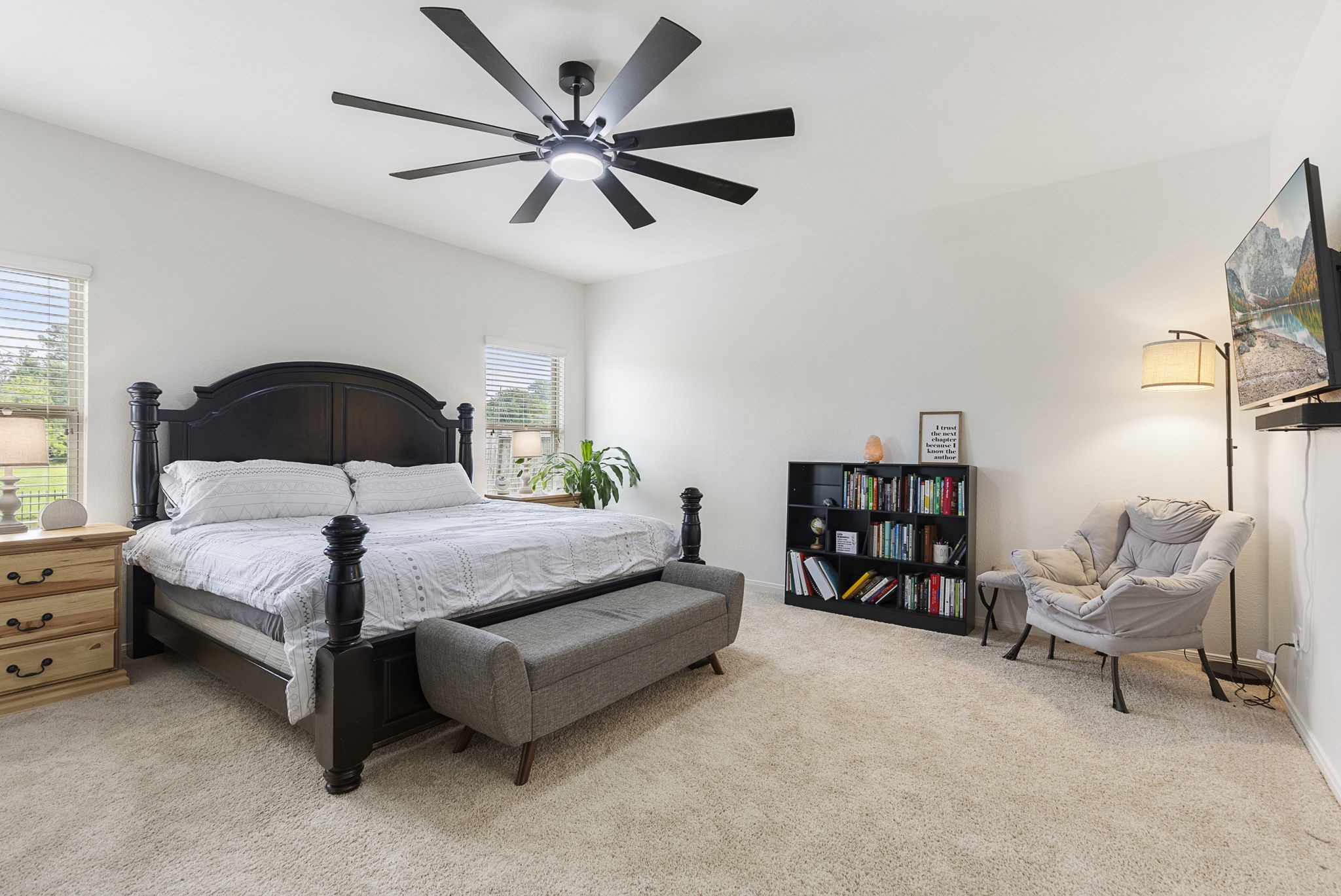 Primary suite privately tucked away on the first floor with brand new carpet, upgraded ceiling fan and awesome backyard views.