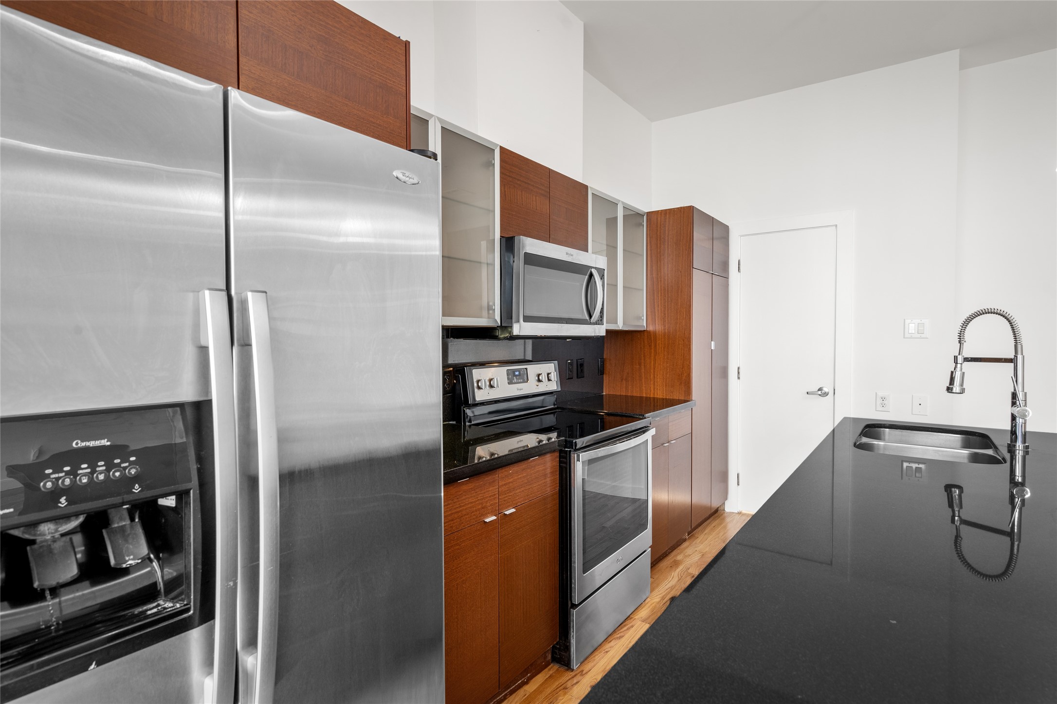 Well-appointed kitchen featuring stainless steel appliances, a spacious island with a sink, and plenty of counter space, perfect for cooking and entertaining.
