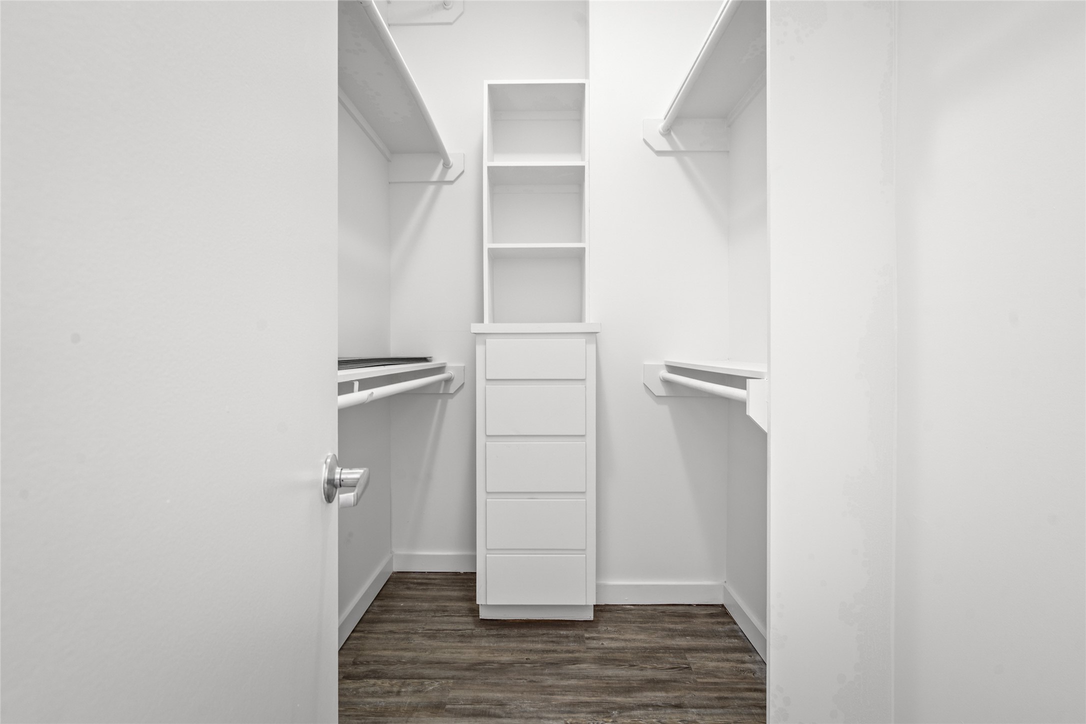 Spacious walk-in closet offering ample storage and organization, perfect for keeping your wardrobe neatly arranged and easily accessible.