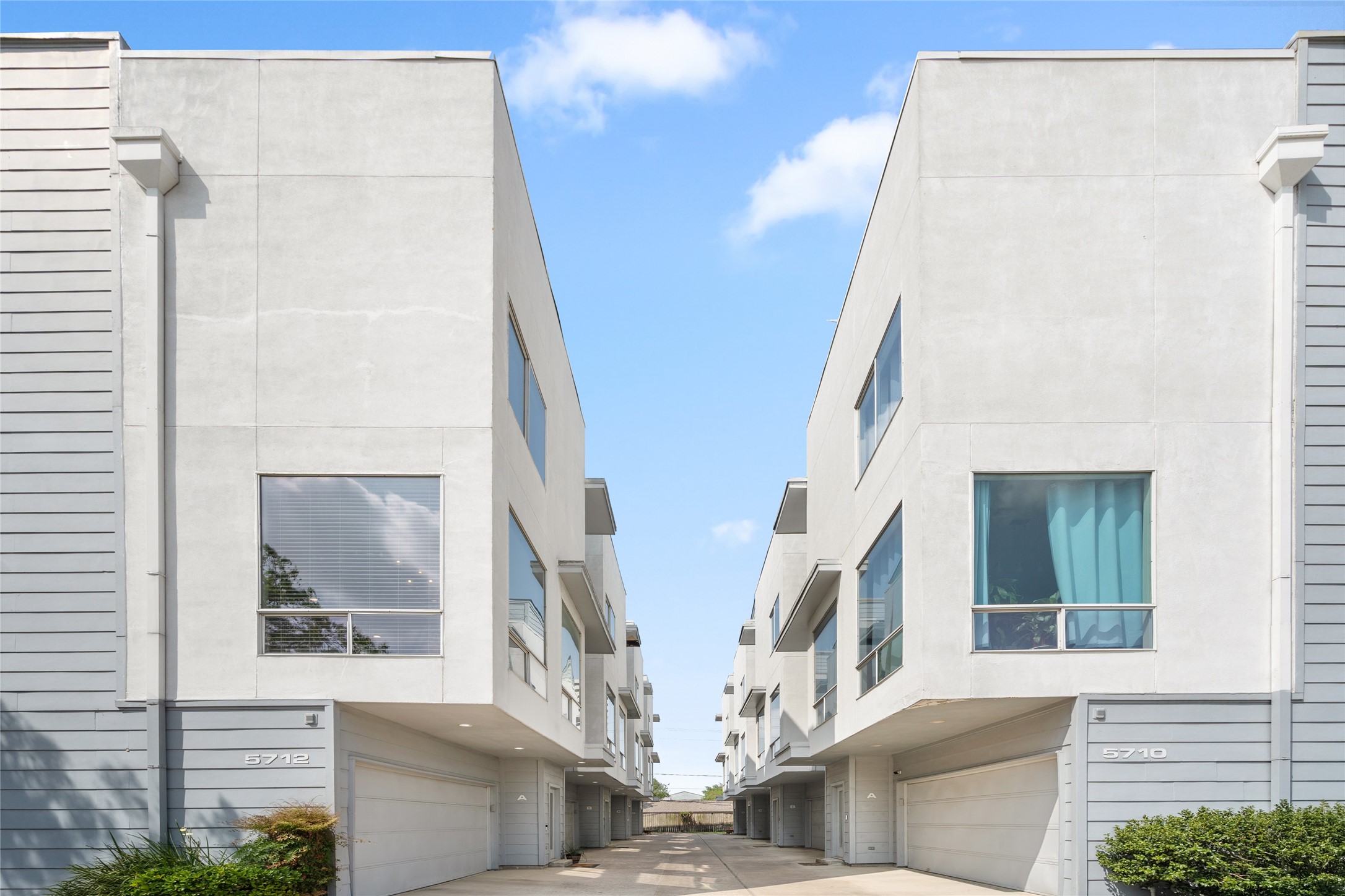 Stylish and well-maintained townhome community with a modern aesthetic. Gated entrance and private garages provide security and convenience. A prime location with contemporary design and spacious layouts.