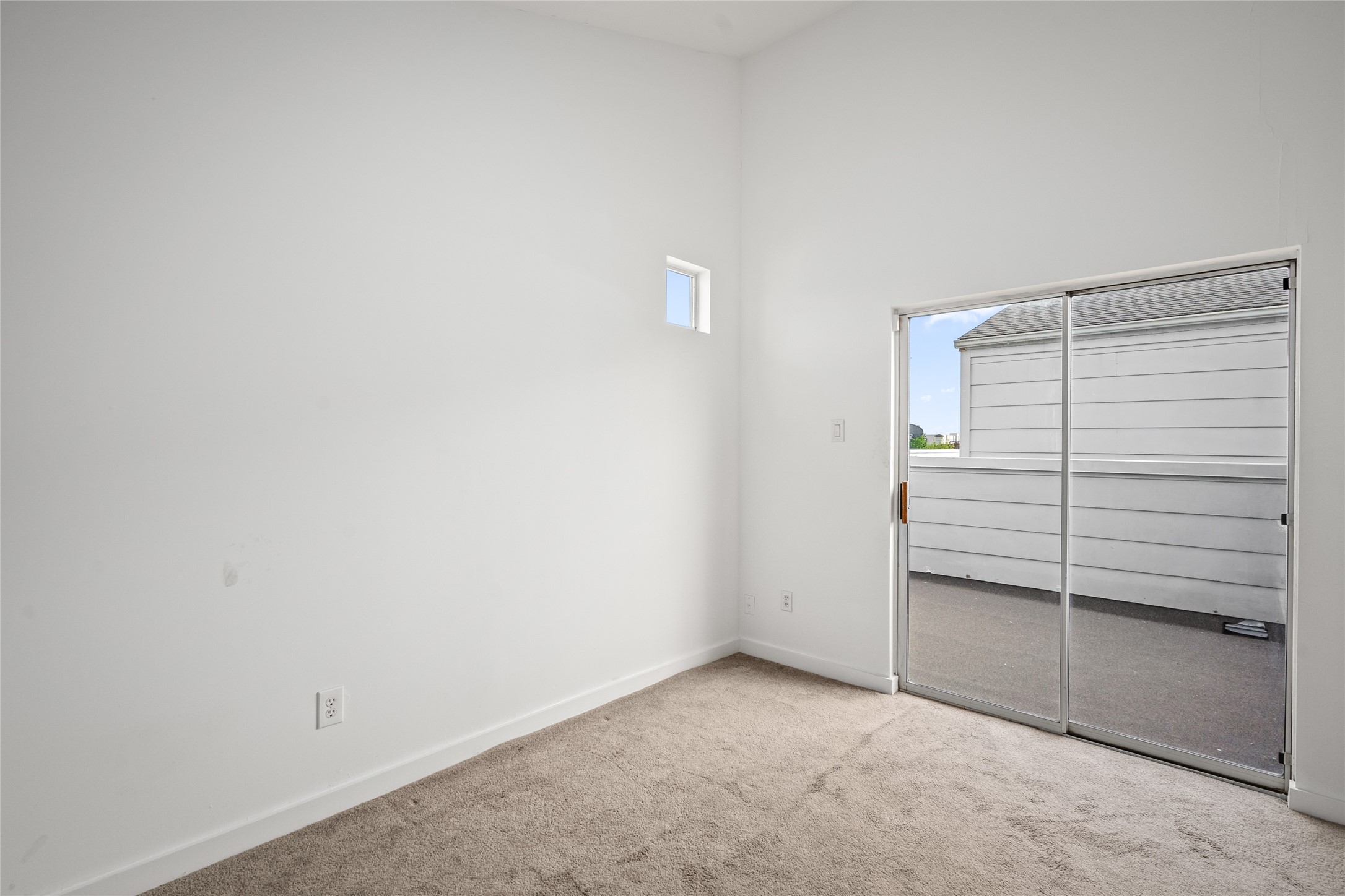 Sliding glass doors lead to the expansive rooftop terrace, seamlessly blending indoor and outdoor living. Enjoy effortless access to your private outdoor oasis, perfect for entertaining or unwinding while taking in the views.