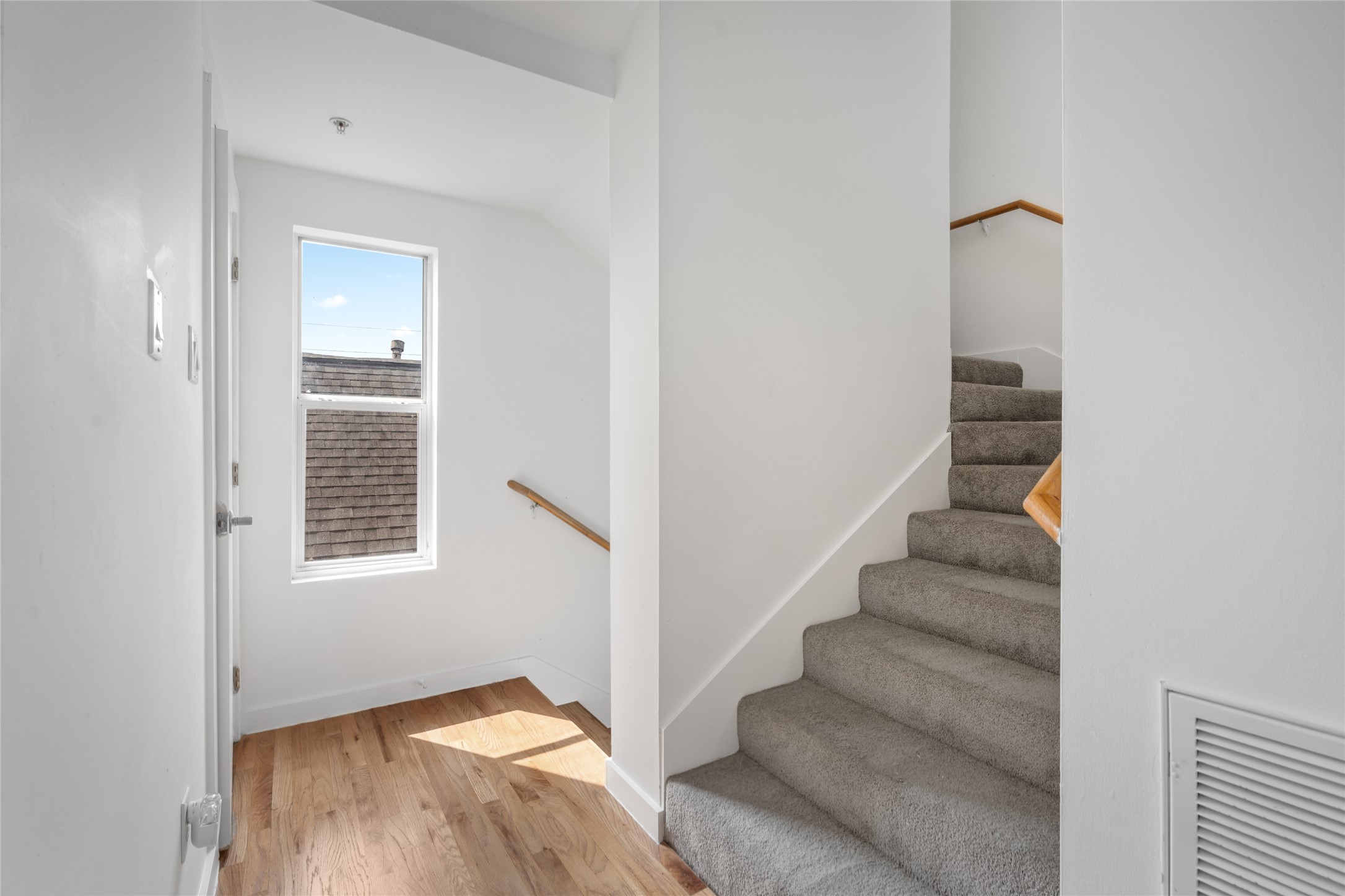 Stairs going to the rooms on the 3rd floor. Utility closet on the right side.
