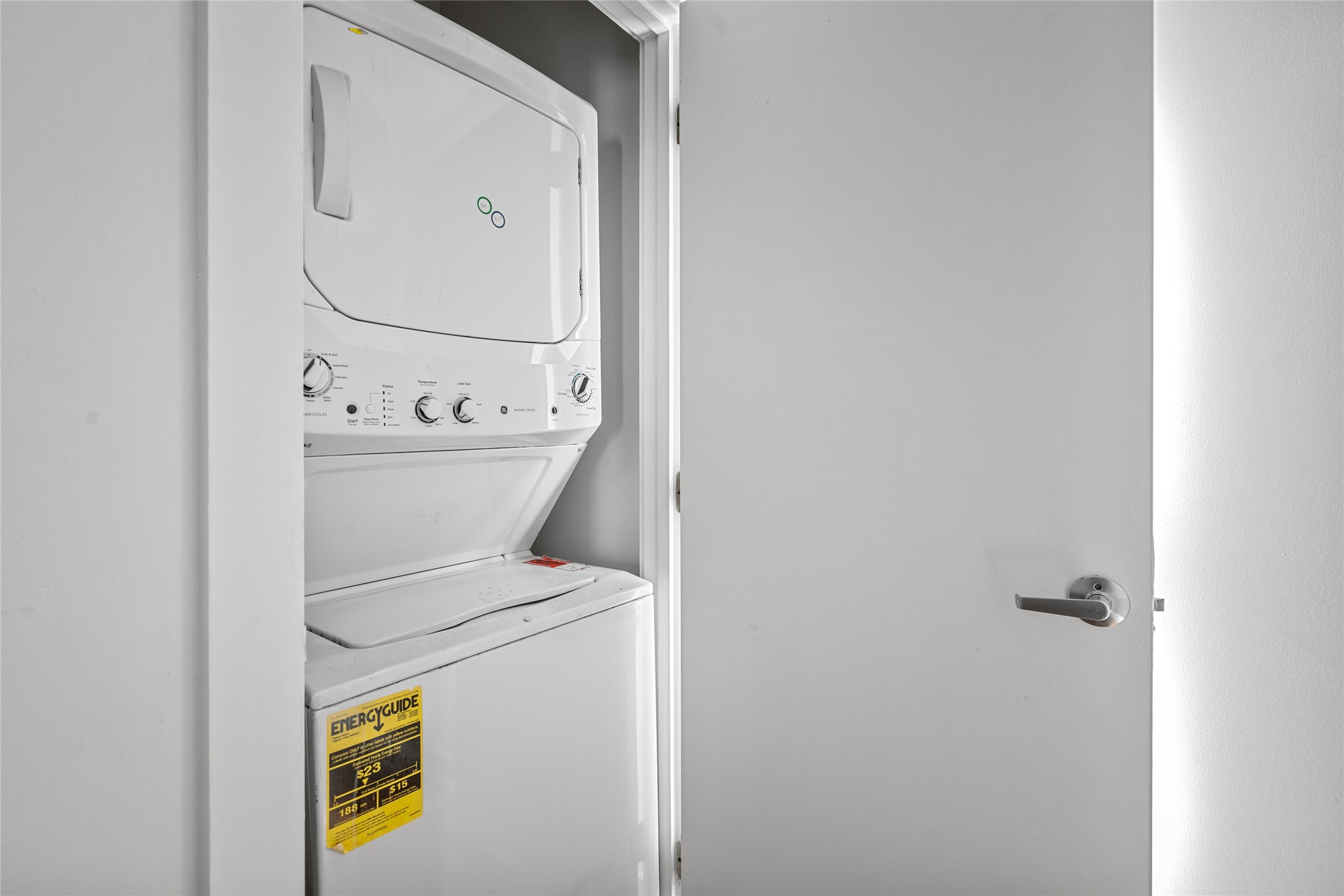 This utility closet is designed to accommodate a washer/dryer combo, offering a convenient and space-saving laundry solution.
