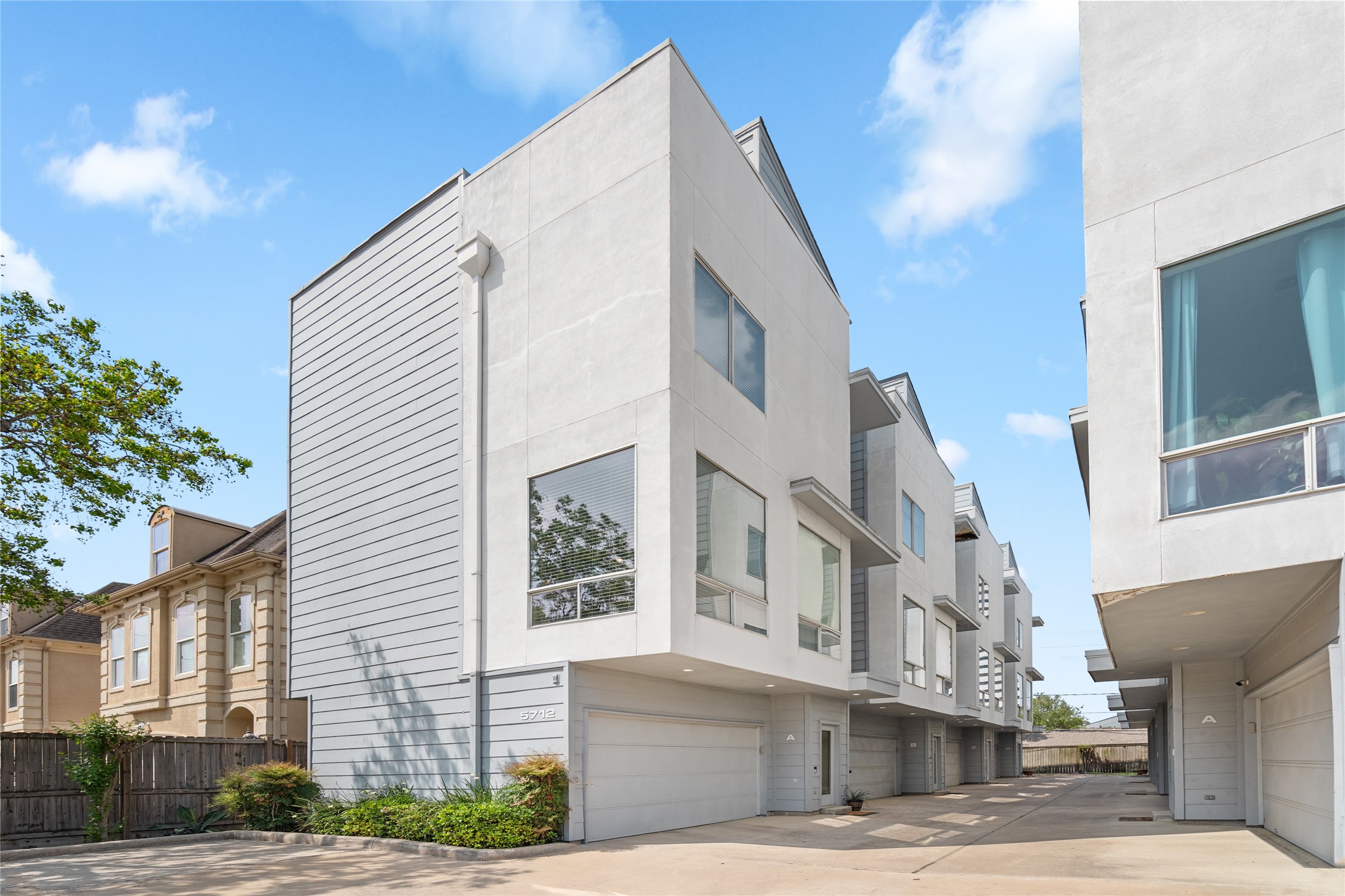 Modern three-story townhome in a gated community. Sleek contemporary design with large windows for natural light and a spacious two-car garage. Prime location with a private and secure setting.