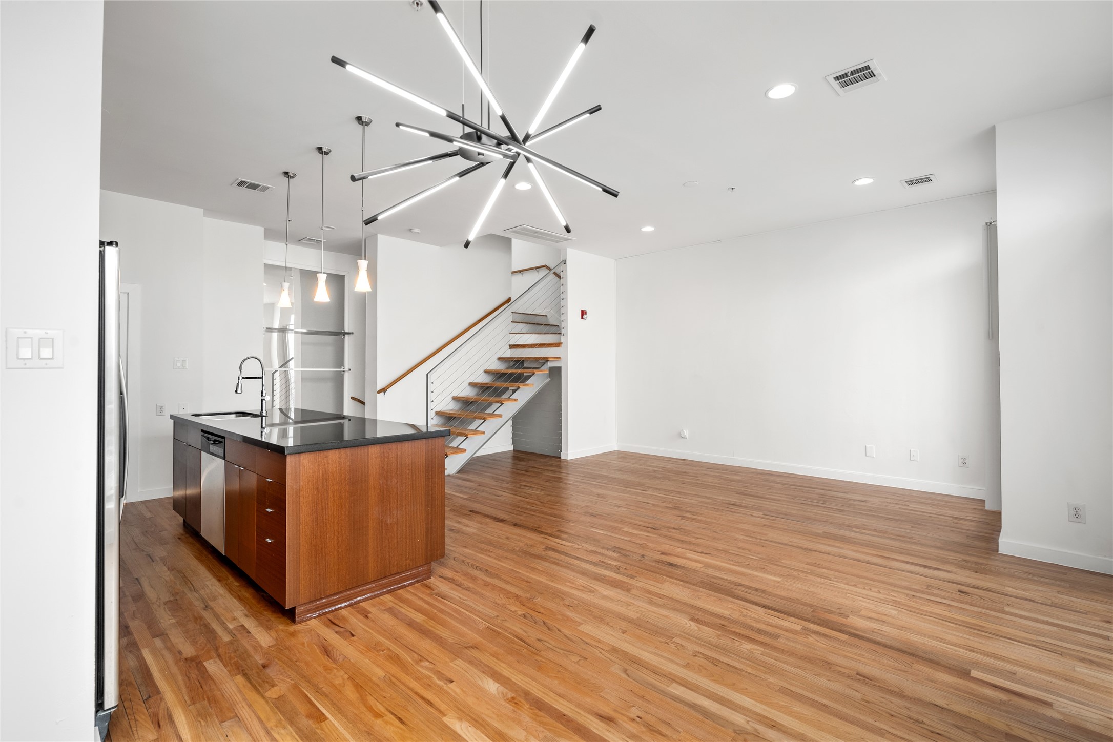 Open concept layout that seamlessly connects living, dining, and kitchen areas, creating a spacious and airy environment perfect for modern living and entertaining.