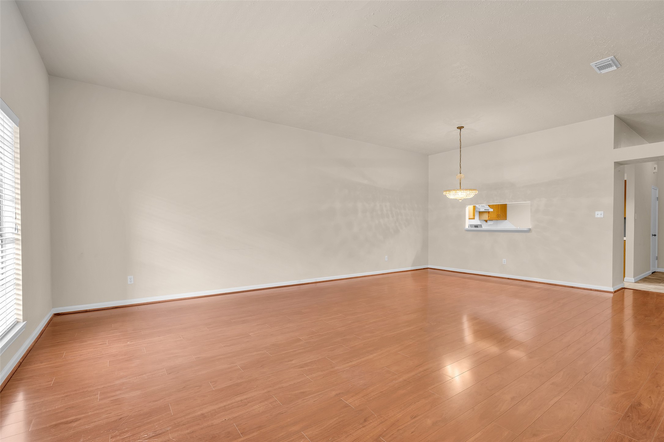 Open layout view of the living room and dining area, designed to create a seamless flow between spaces.