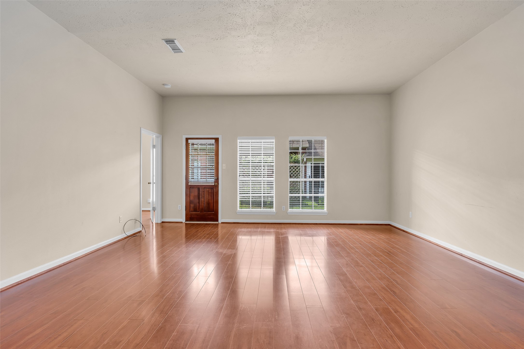 A second door at the corner of the living room provides direct access to the primary bedroom, adding convenience and a well-connected layout to the main living space.