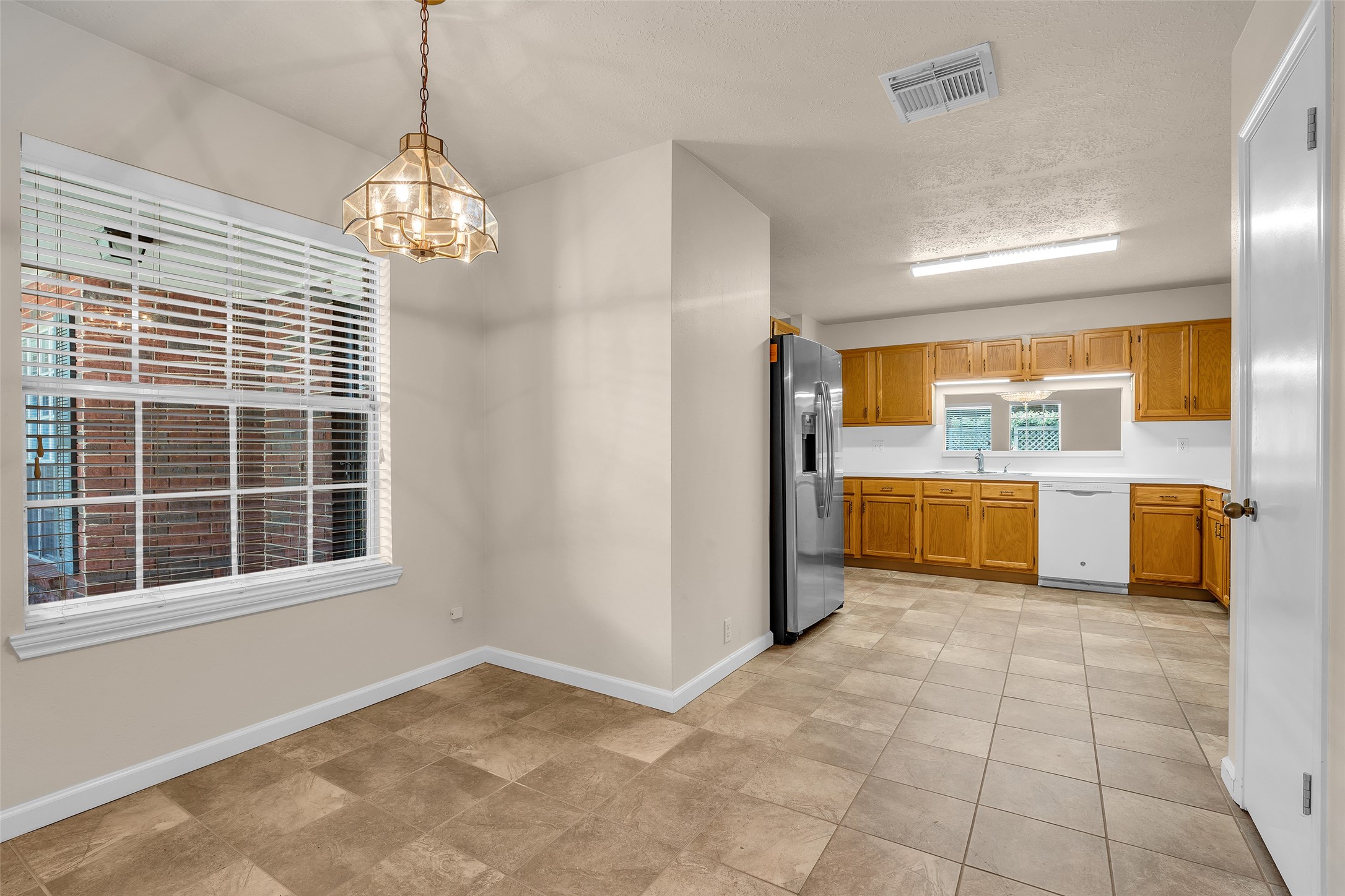 The breakfast nook offers an open view that extends directly into the kitchen, creating a connected and functional layout.