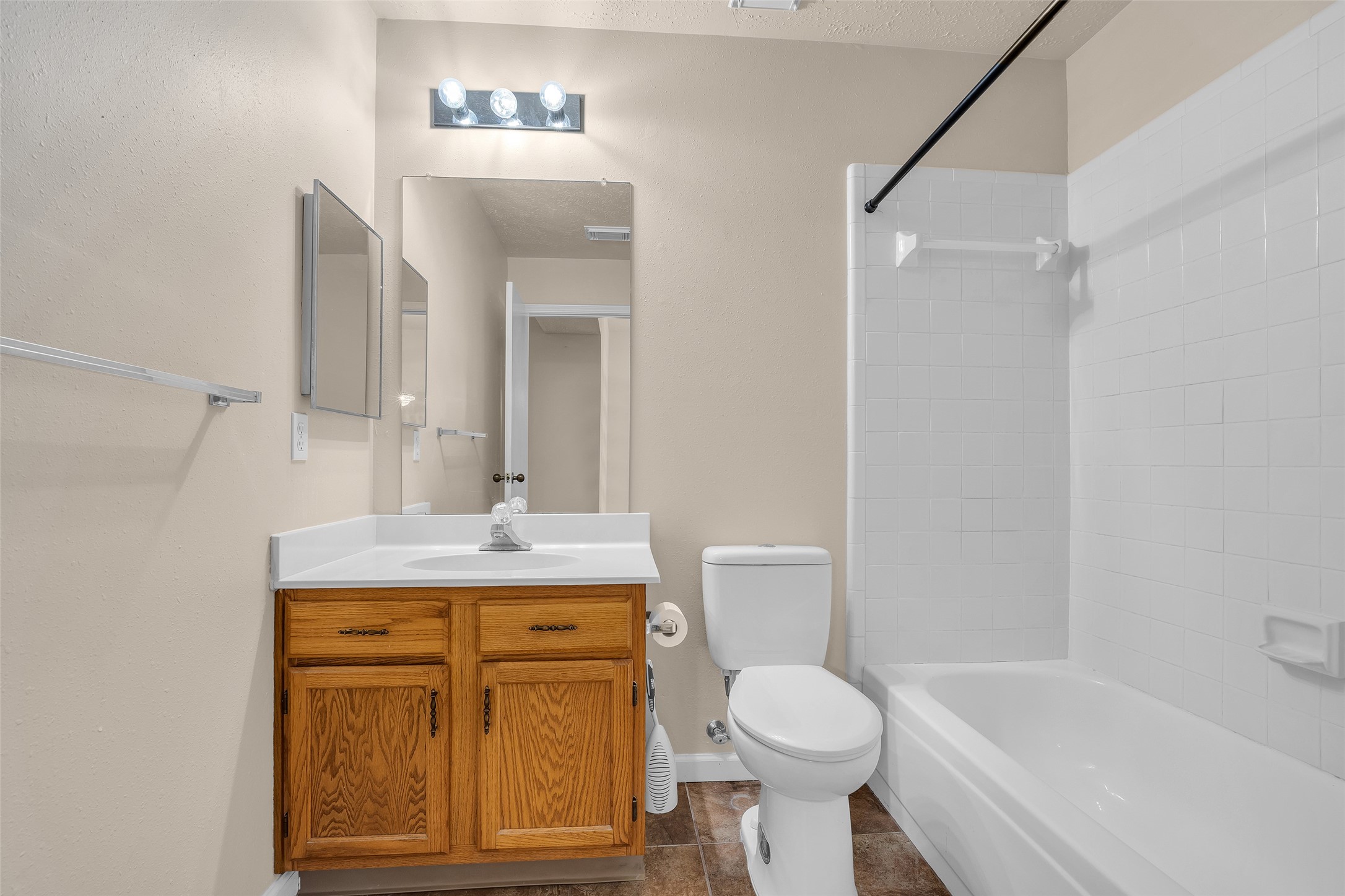 Secondary bathroom featuring a tub and shower combination with modern fixtures, designed for practical everyday use and easy maintenance.