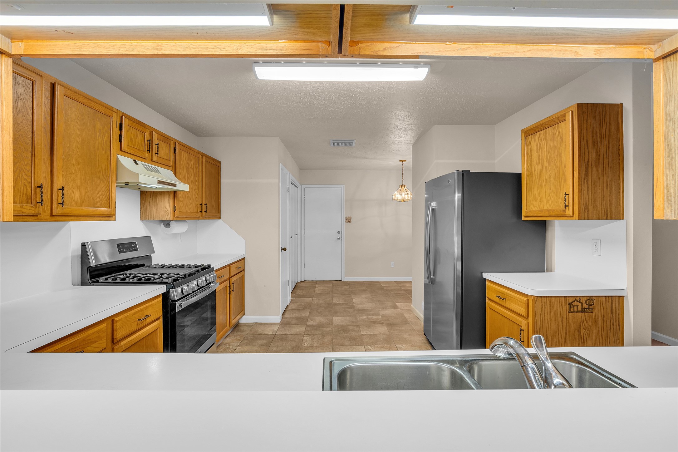 Laminate countertops add a practical and easy-to-maintain surface to the kitchen, complementing its functional design.