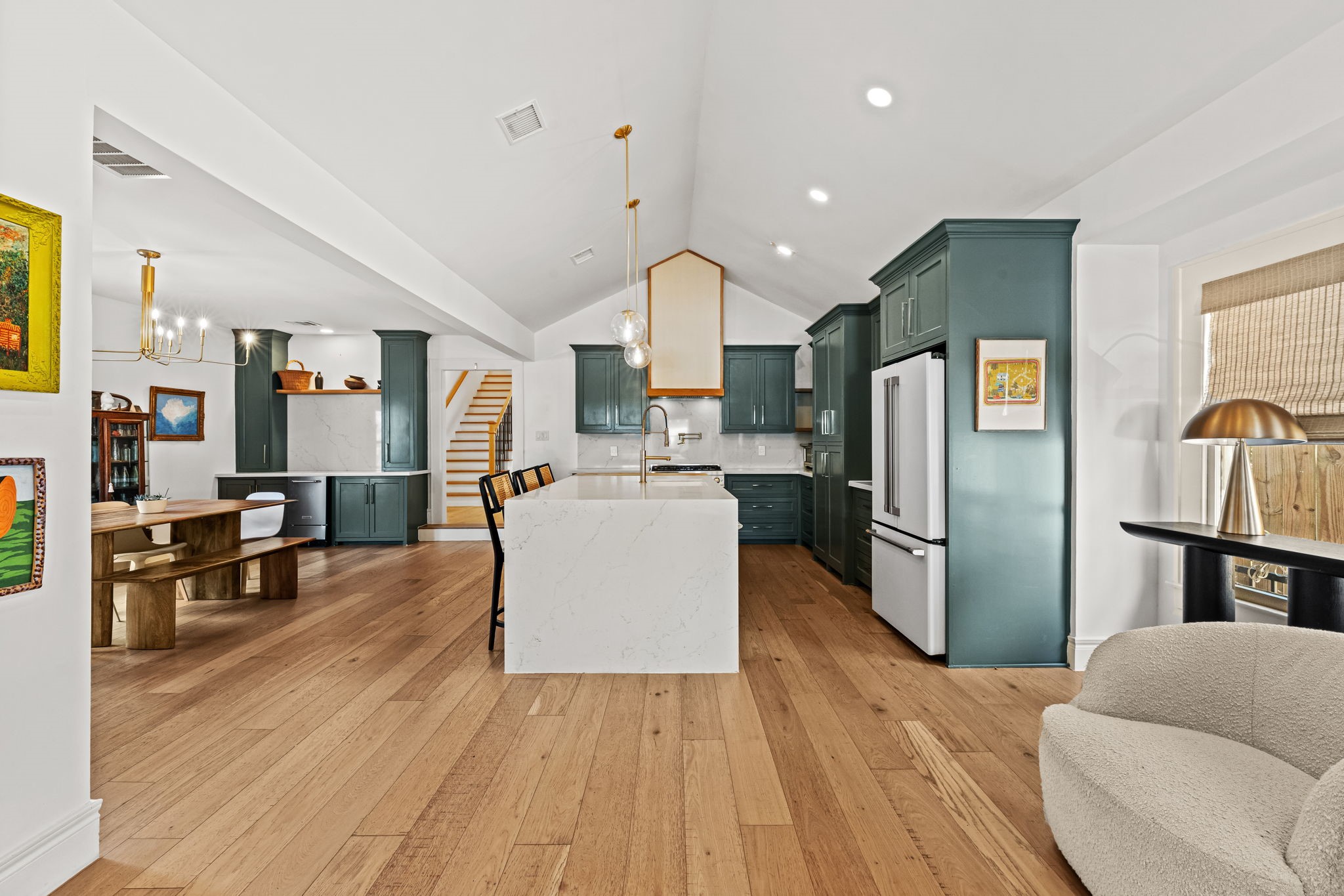 Living room flows seamlessly to the kitchen with massive island Living room flows seamlessly to the kitchen with massive island