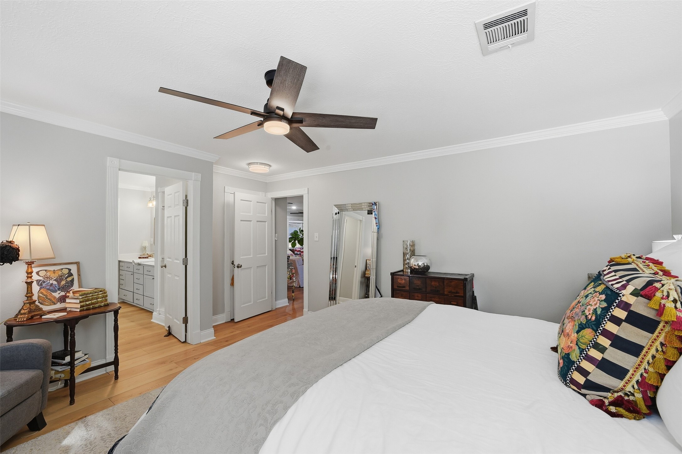 Primary bedroom with crown molding and lots of light and storage.