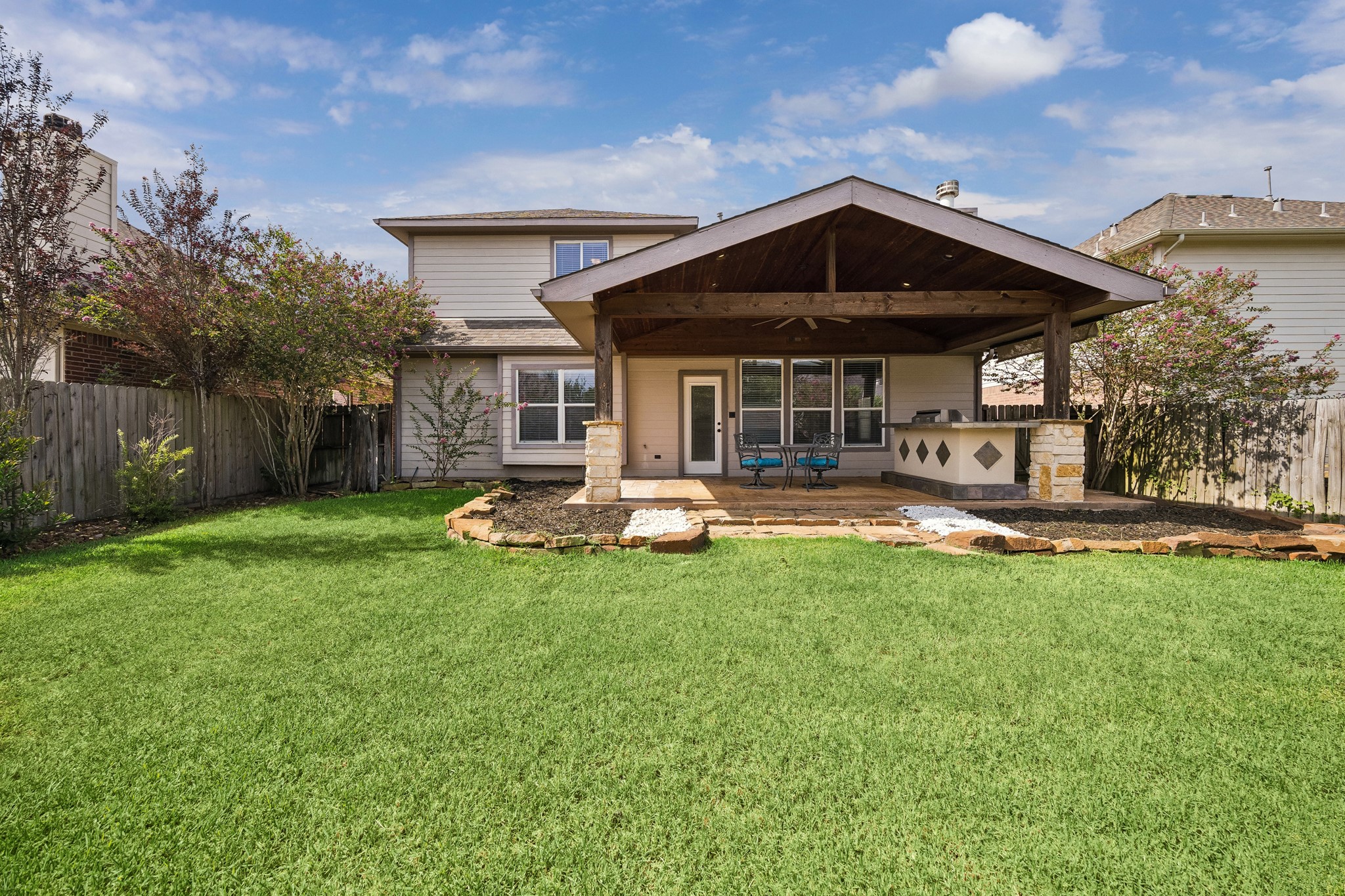 Beautiful backyard with extended covered patio and outdoor kitchen. Beautiful backyard with extended covered patio and outdoor kitchen.