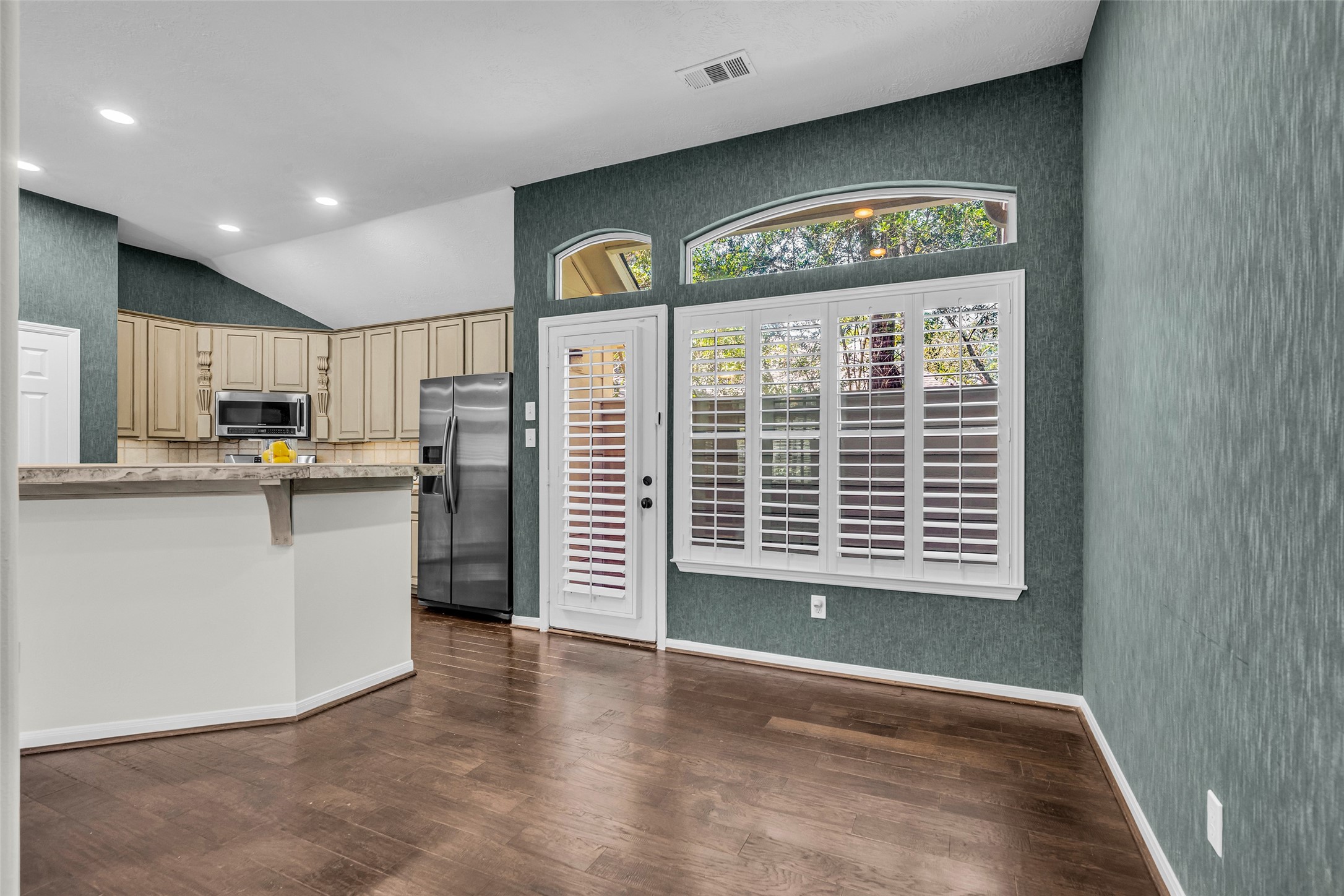 Breakfast Room with small patio and plenty of windows and plantation shutters