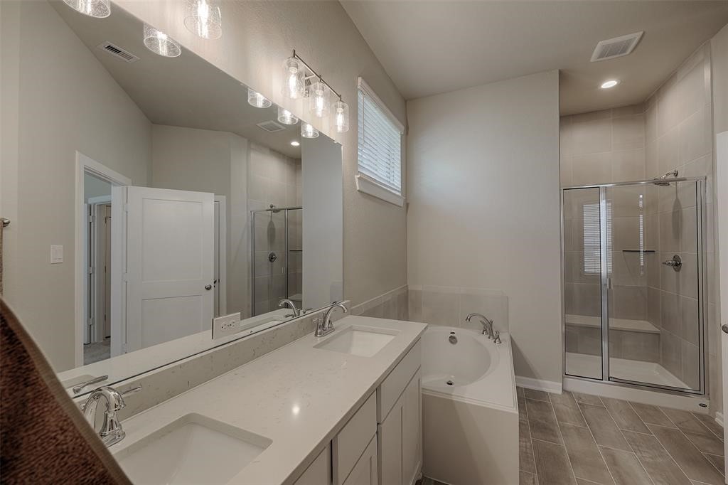 Primary bath has double sinks, soaking tub plus large walk in shower with seat.