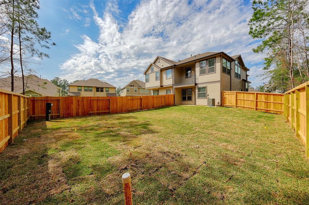 Rear view of the townhome ground level patio and main living are balcony.