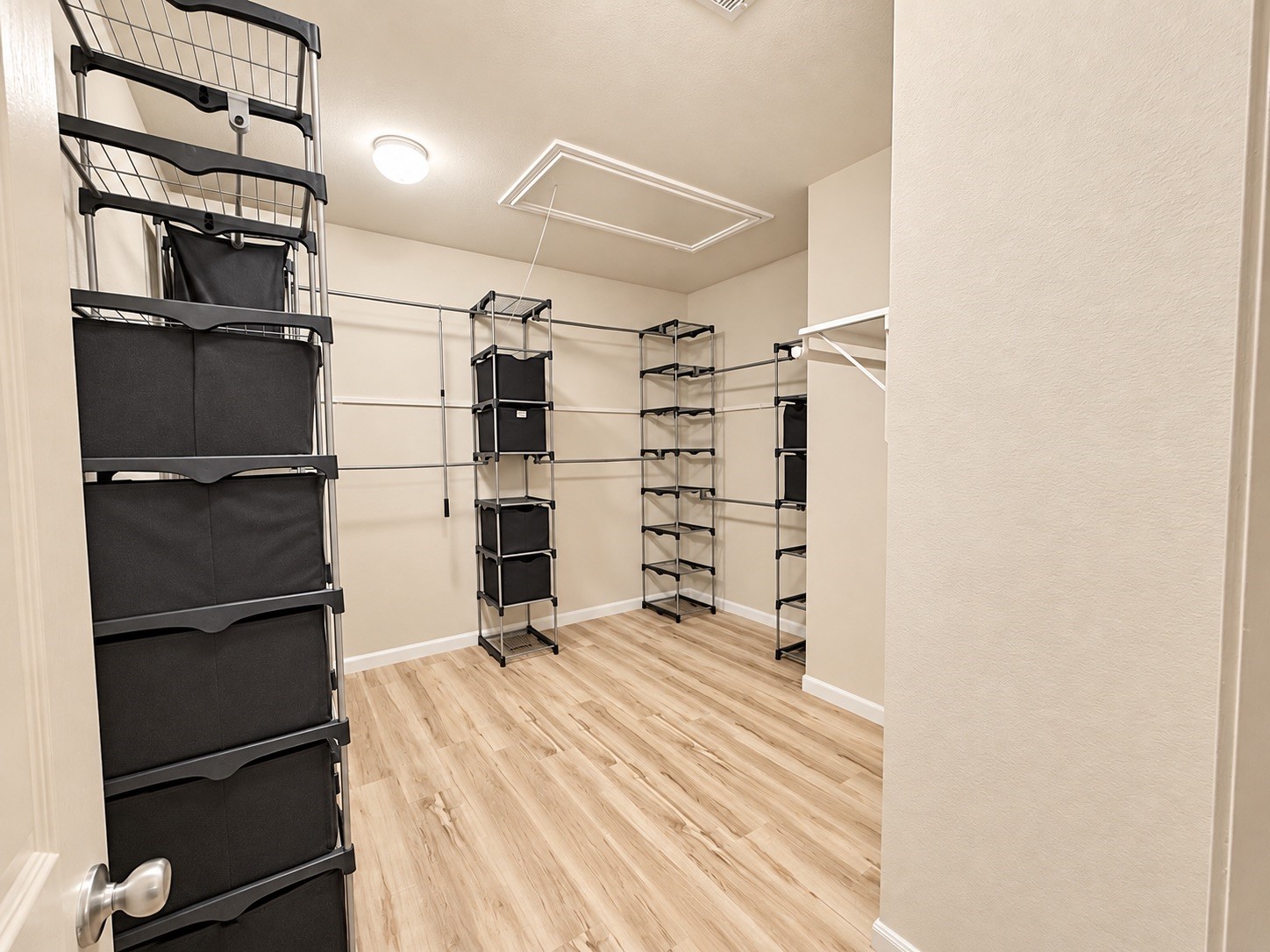 This spacious master closet features a highly organized layout with ample storage solutions.