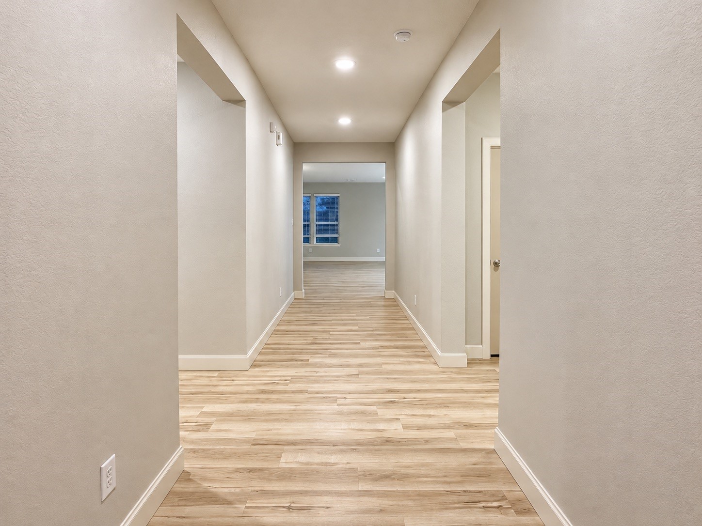 The wide entryway seamlessly guides you toward all sections of the home, creating a fluid and welcoming transition throughout the open floor plan.