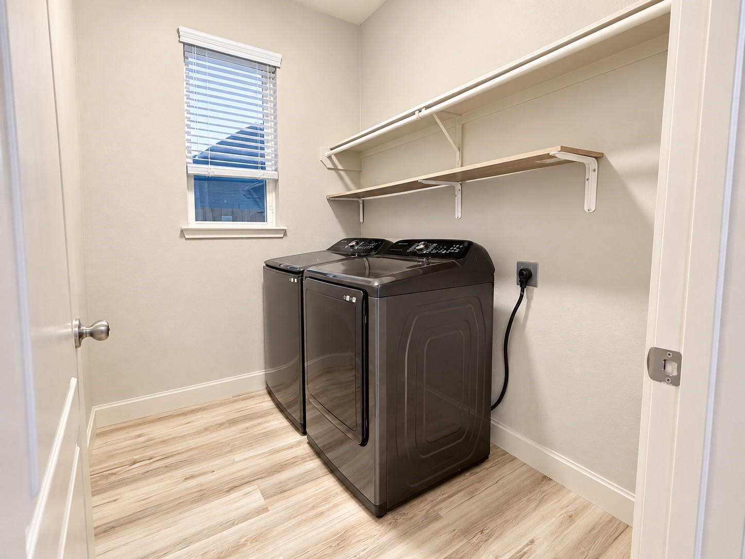 This laundry room offers a spacious layout with ample storage throughout.