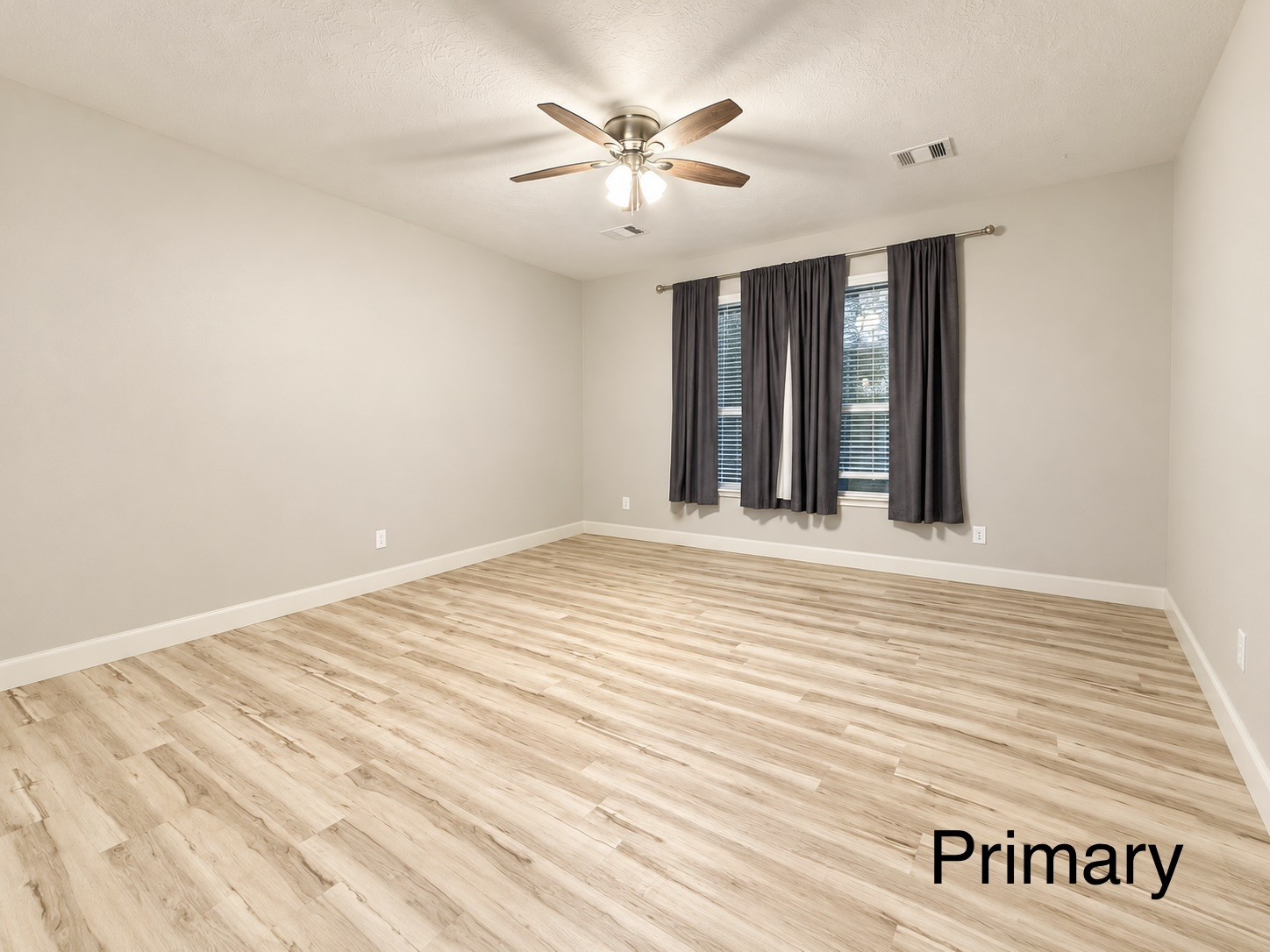 The primary bedroom is conveniently located off the living space and separate from the other bedrooms, offering a private retreat.