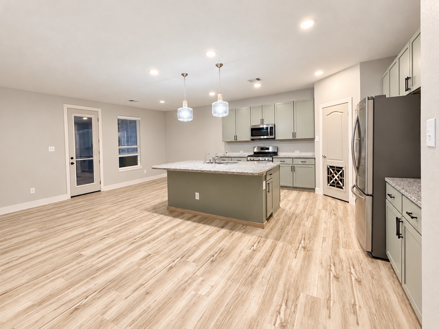 This kitchen features an abundance of cabinet space, complemented by a spacious pantry and beautifully finished cabinetry.