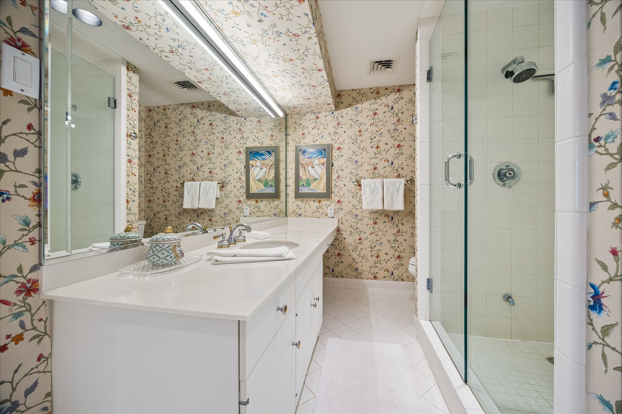 Primary bathroom with seamless glass shower.