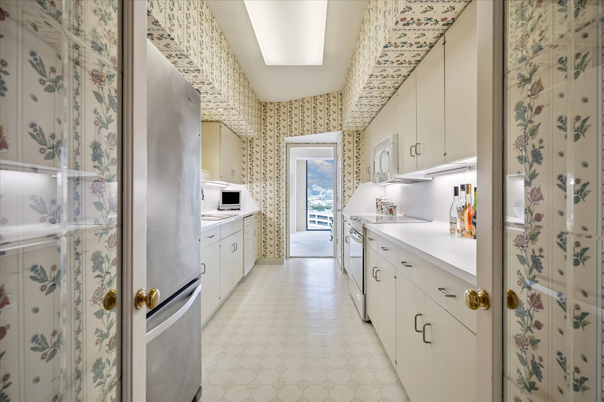 Double glass paneled doors at the kitchen entry.