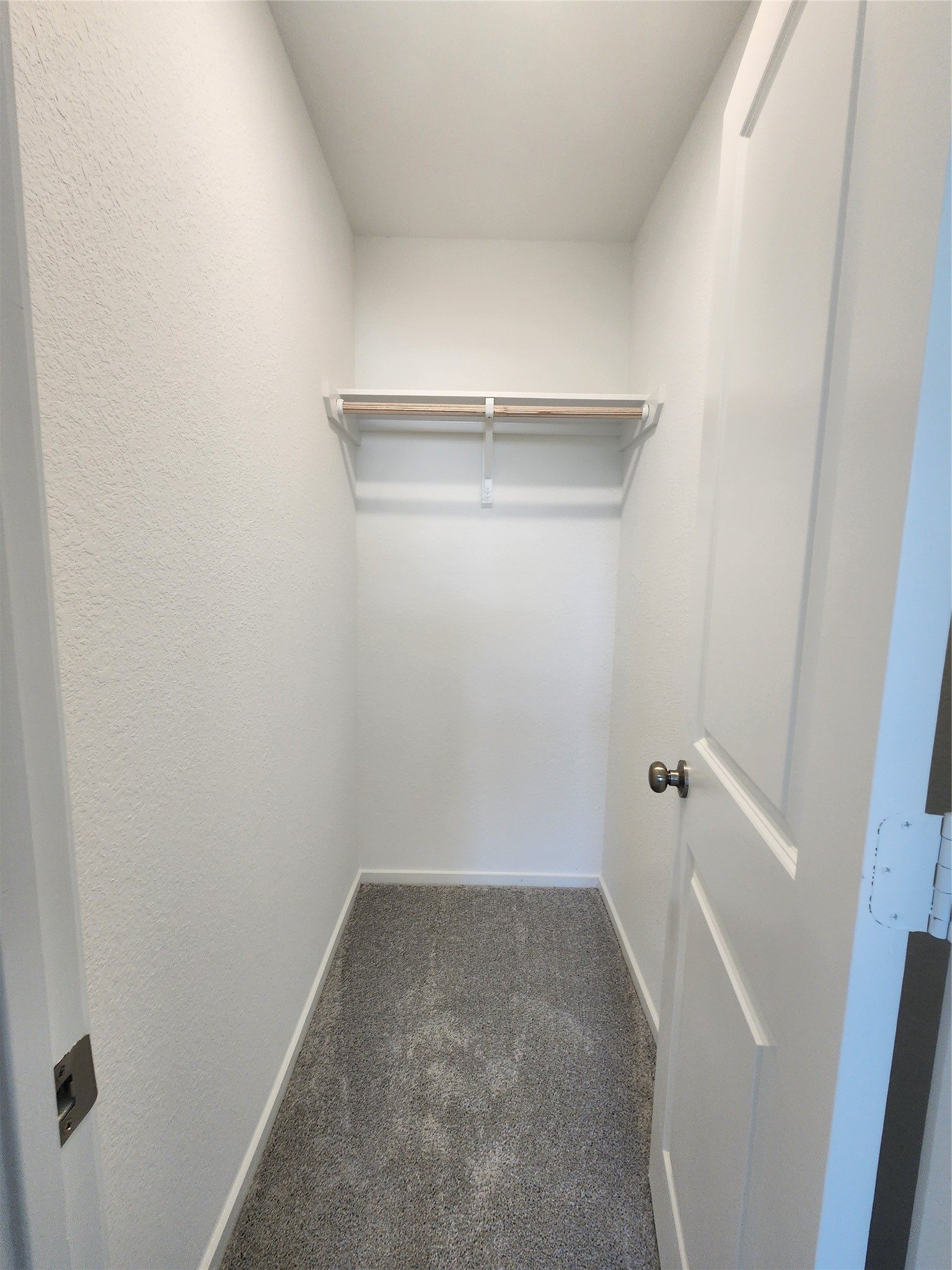 Photo of the secondary closet in the secondary bedroom.