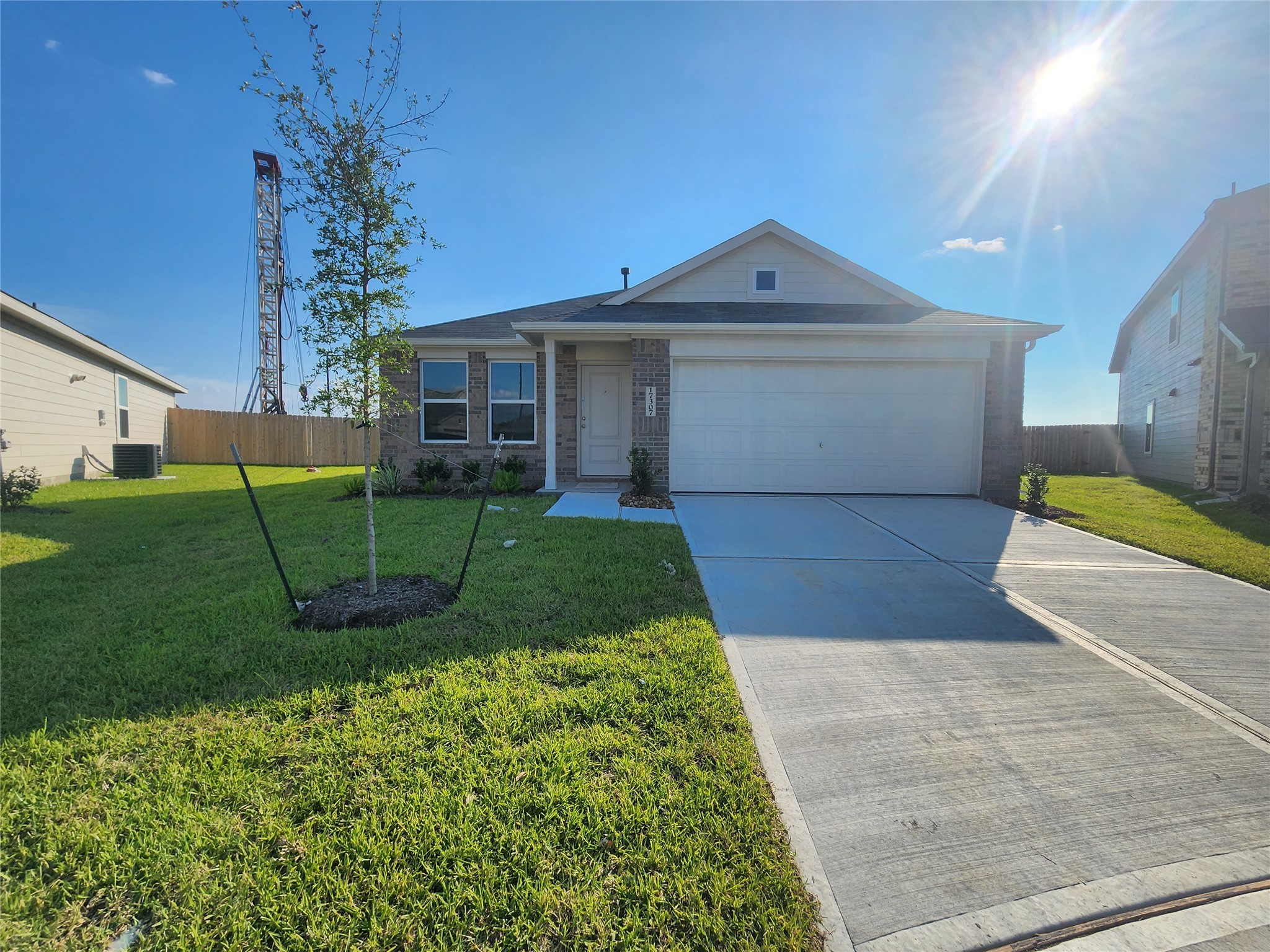 Single-story, brick modern home with a two-car garage situated on a cul-de-sac.