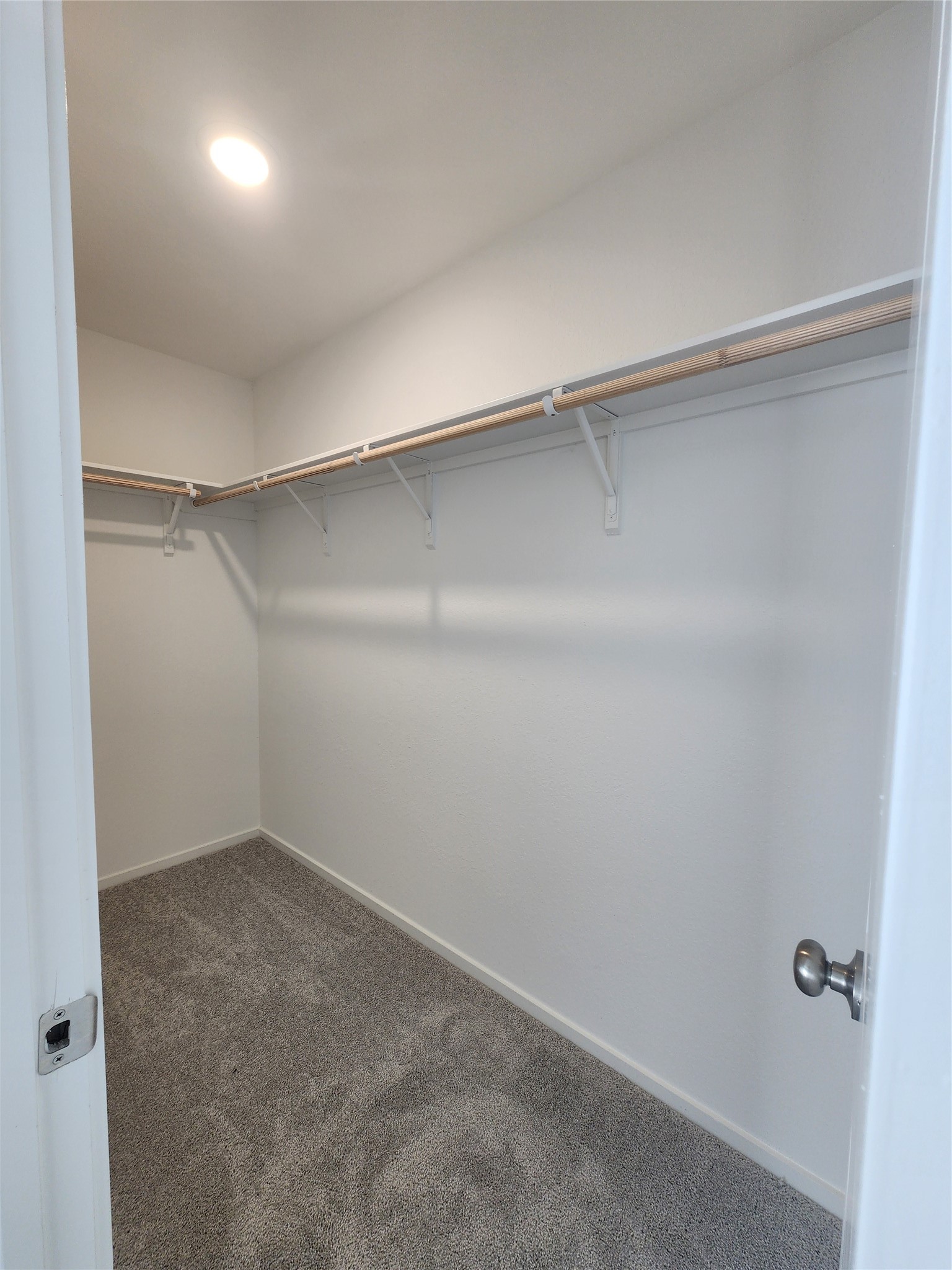 Spacious walk-in closet in primary bedroom.