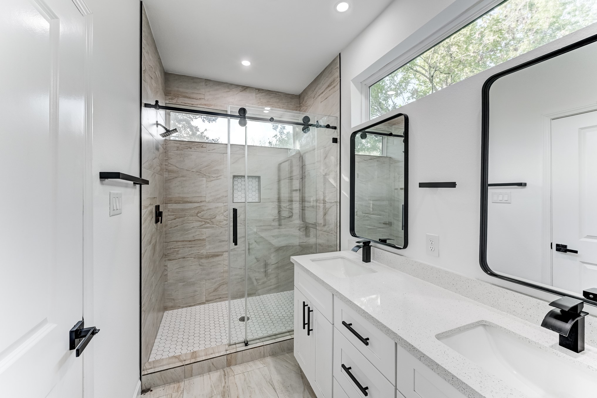 Primary bathroom with glass enclosed shower