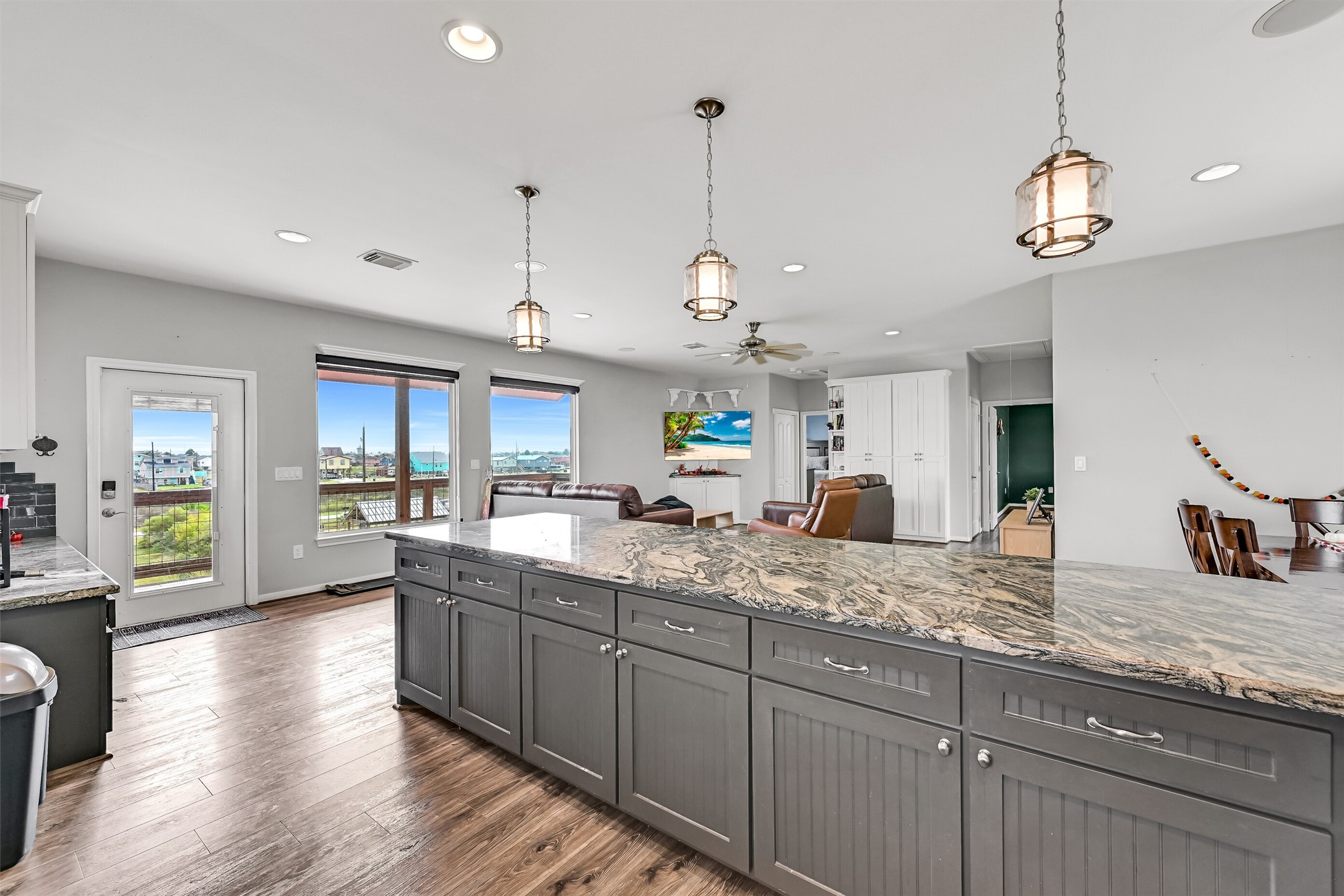 Lots of space to entertain! You will even enjoy a water view from your kitchen. Notice the designer pendant lighting above.