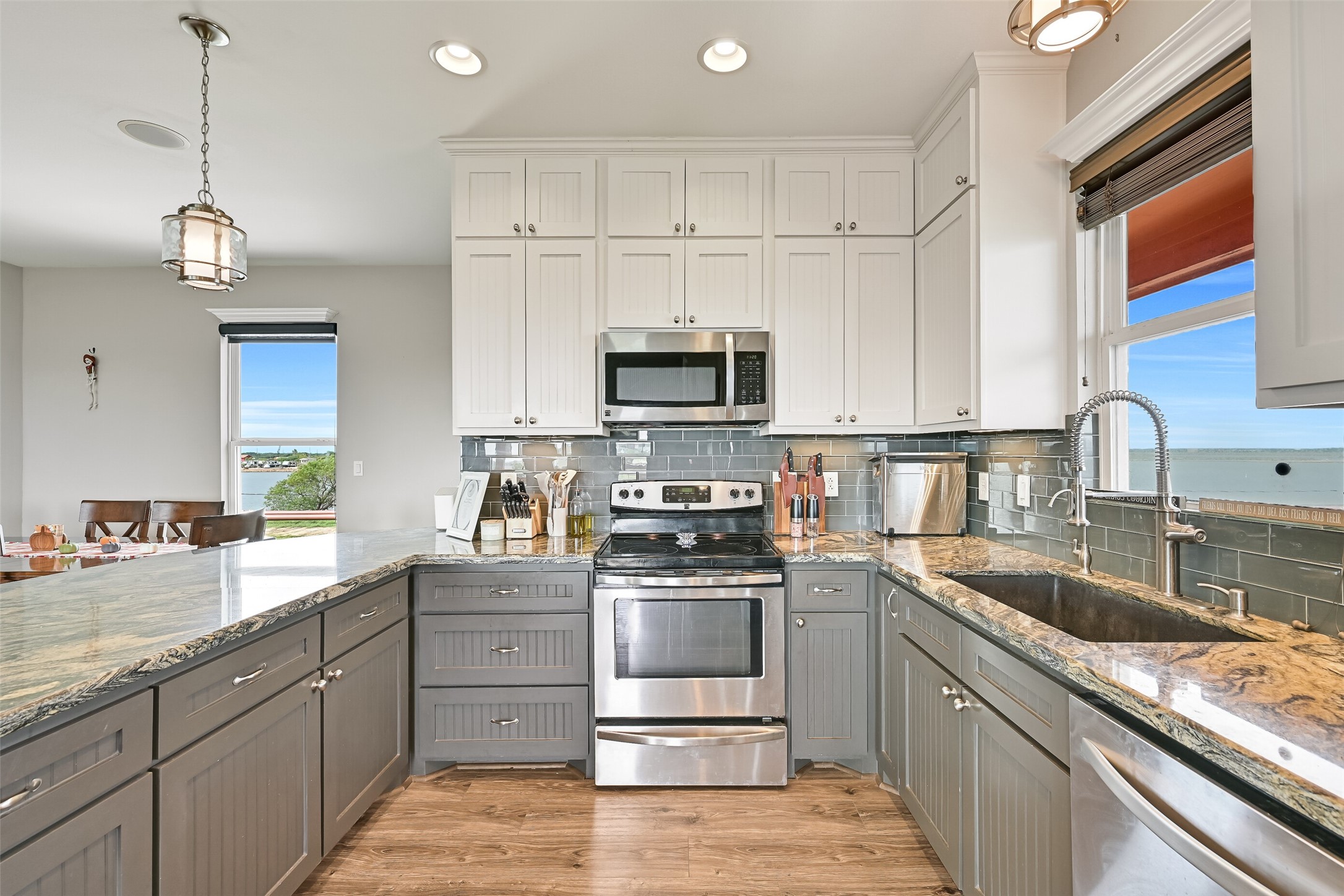 Floor to ceiling shaker cabinets featuring a beadboard accent contrasts with the classic subway tile backsplash. A full suite of stainless appliances is sure to appease your chef at heart.