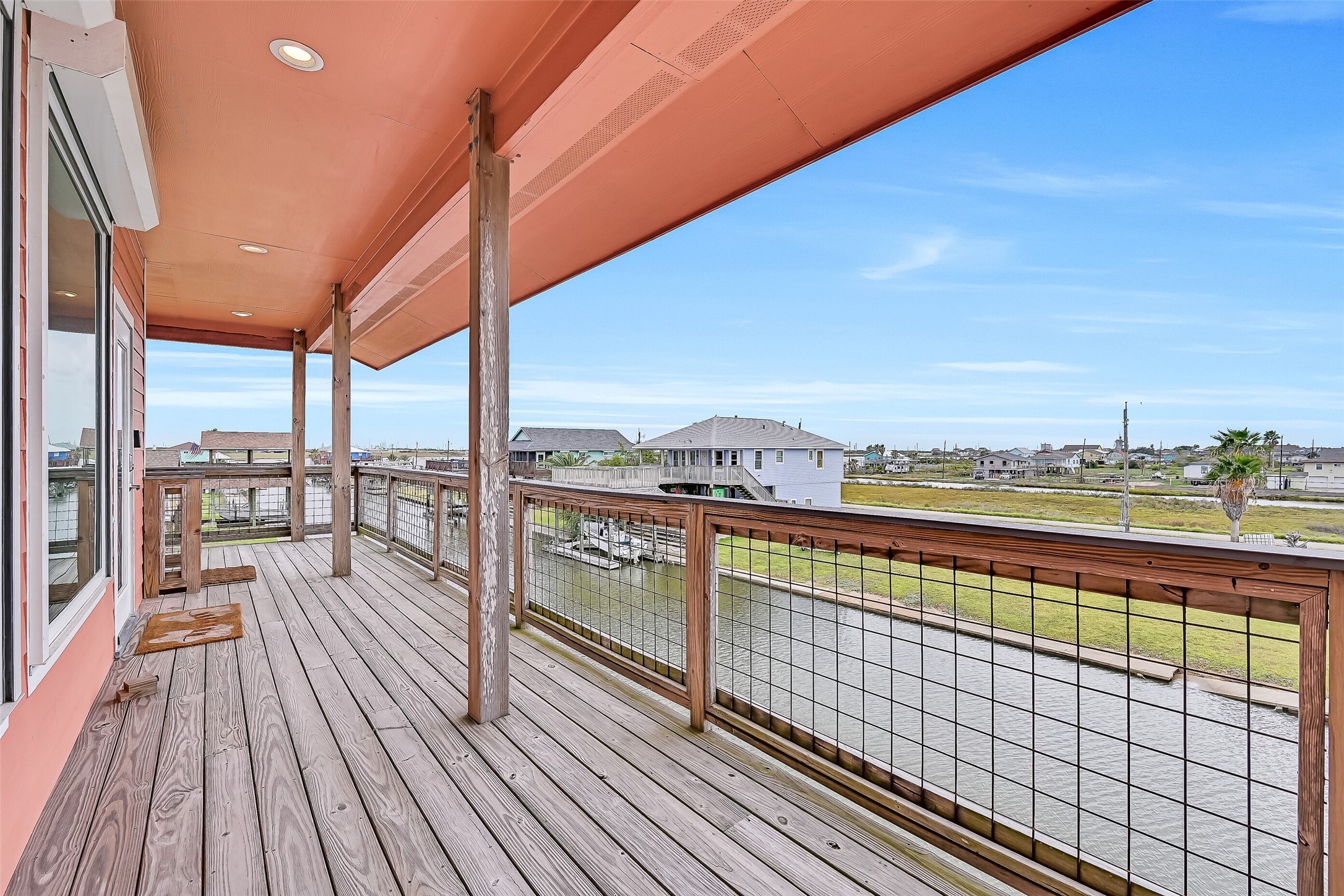 Once on the main level, we come to the expansive wrap-around covered decking. No matter where you are on this deck, you will always have a water view!