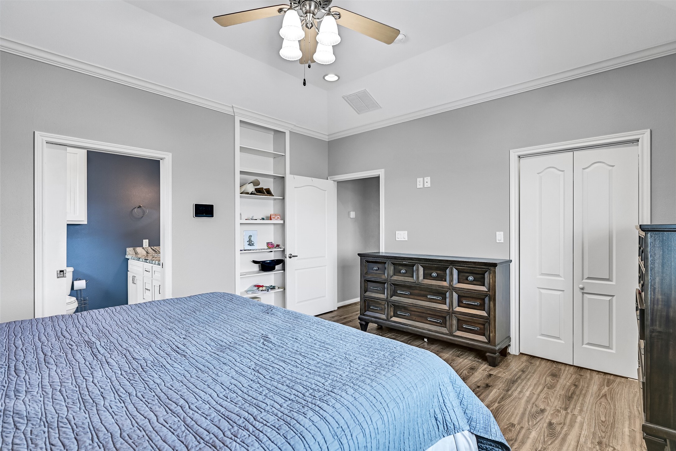 The bi-fold doors reveal a walk-in closet. Notice the built-ins behind the door.