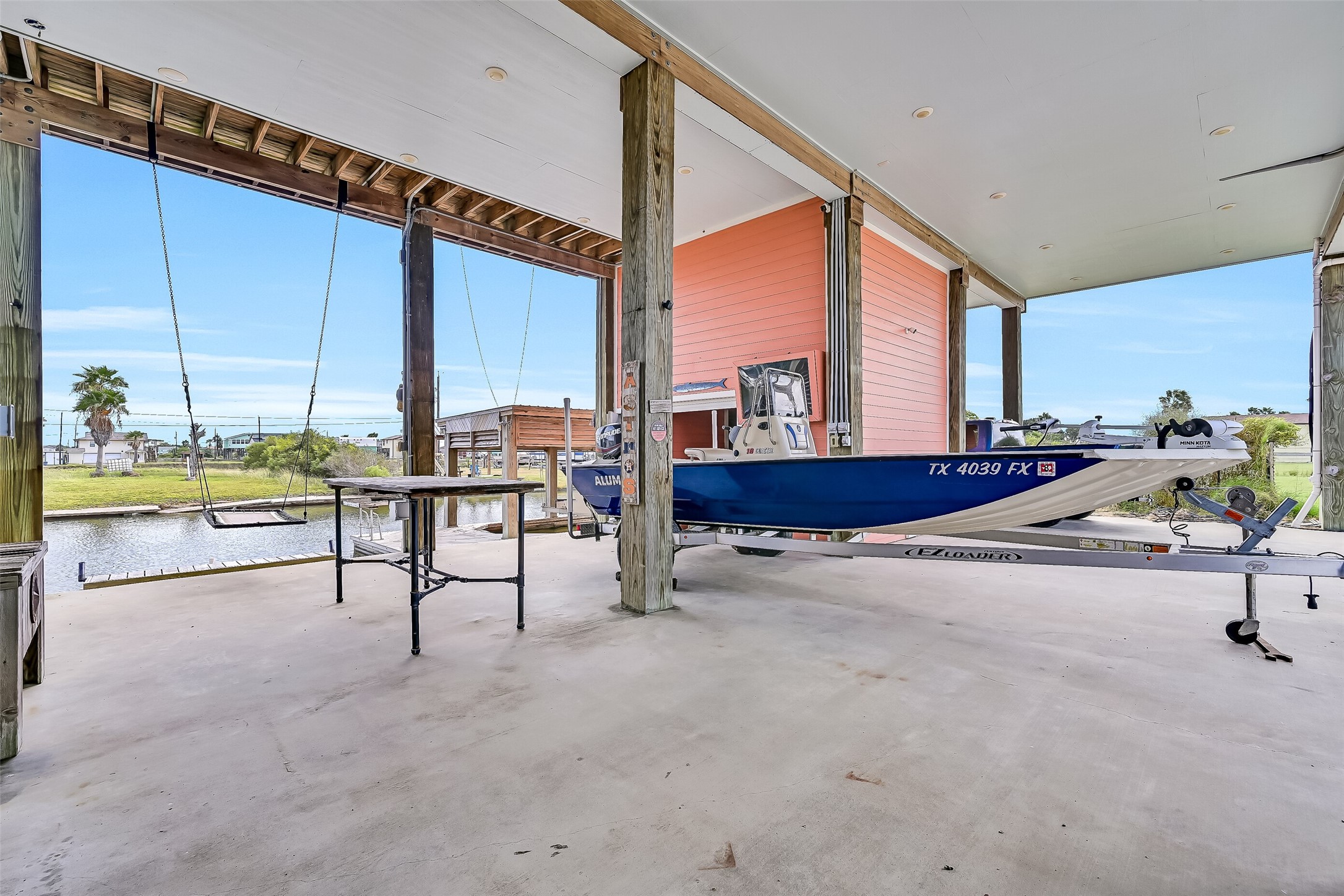 Look at all of this covered entertaining space, which would also be perfect for extra parking. As you can see the boat trailer is stored here.