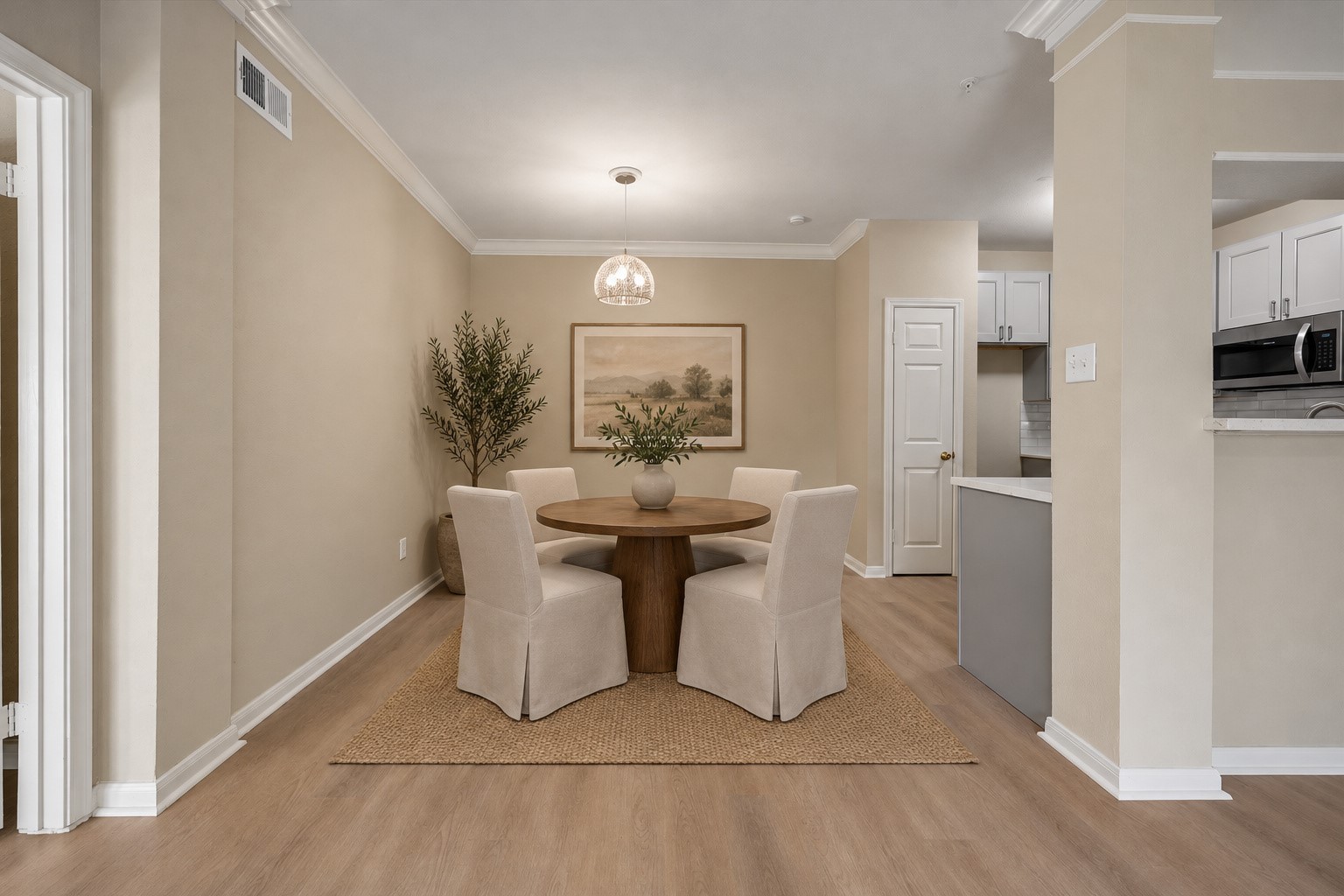 Another view of the spacious dining area conveniently located near the kitchen & open to the living room. Decorative pendant lighting, crown molding & plenty of room for a dining table make this a wonderful space for everyday meals & entertaining! Photo is virtually stage. Another view of the spacious dining area conveniently located near the kitchen & open to the living room. Decorative pendant lighting, crown molding & plenty of room for a dining table make this a wonderful space for everyday meals & entertaining! Photo is virtually stage.