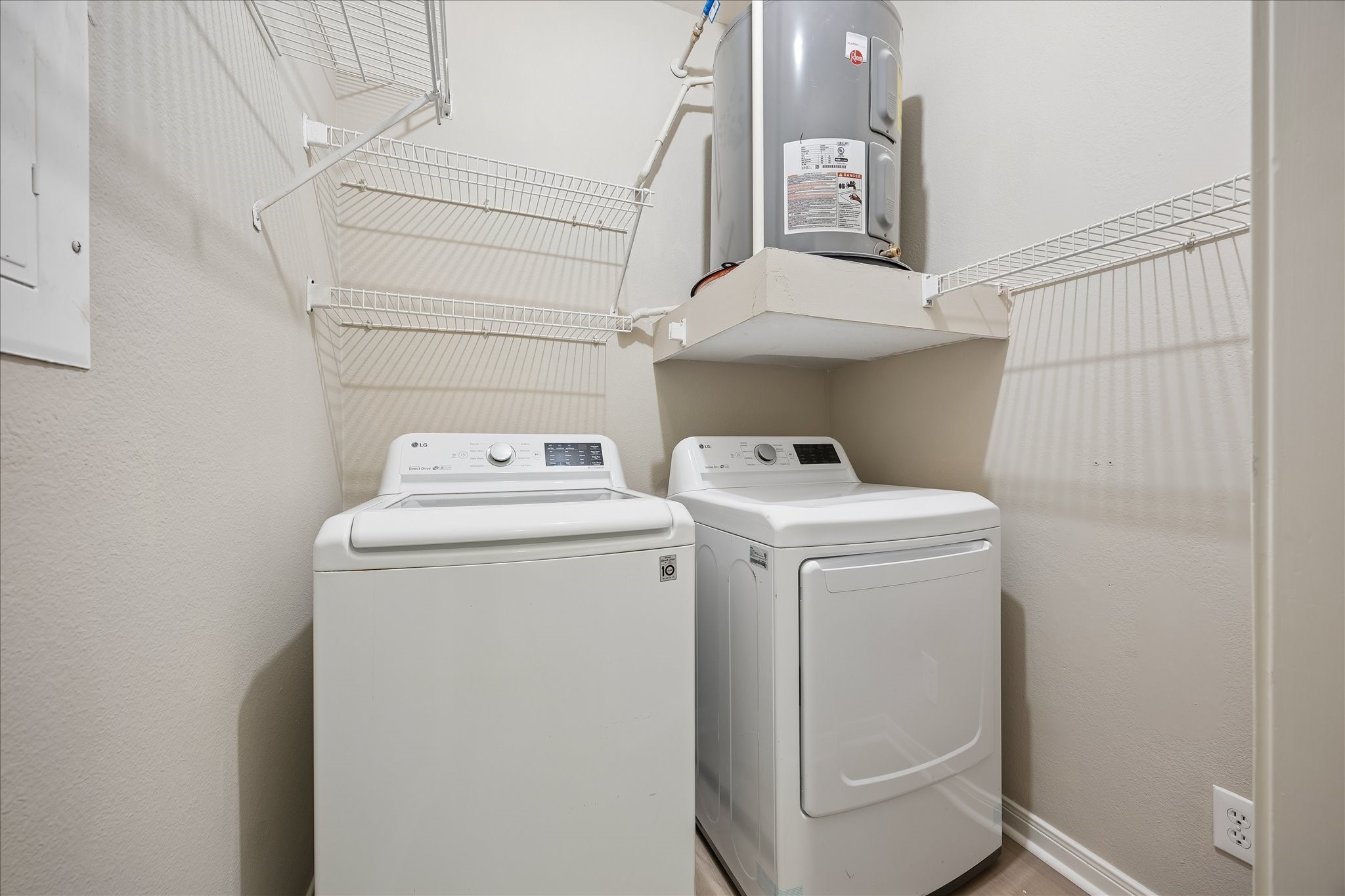 Conveniently located near the entry, the utility room offers a full-size LG washer & dryer, built-in shelving for additional storage & LVT flooring. Washer & dryer included!