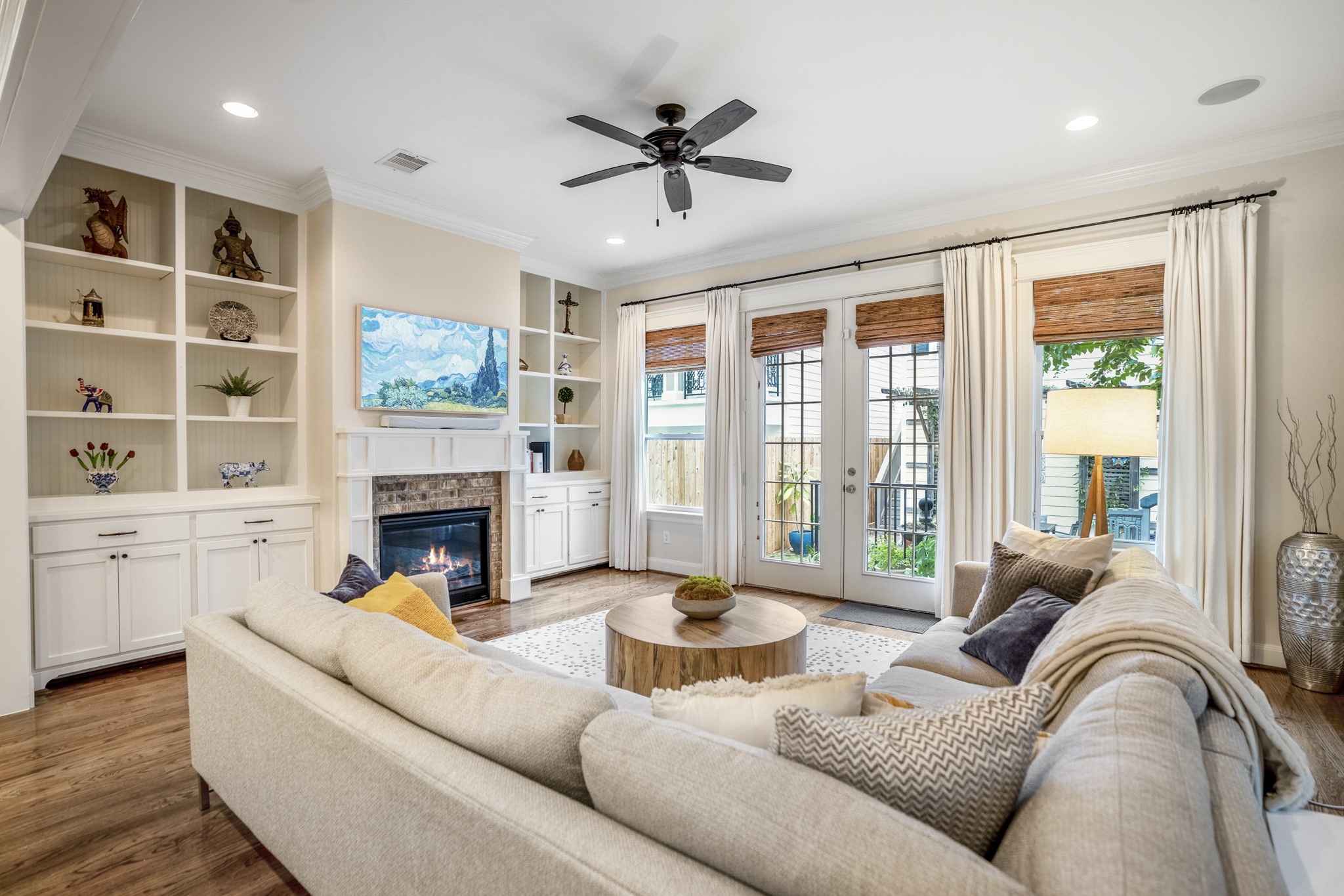Custom built-in book cases flank the gas fireplace. Double French doors lead to your gated backyard space.