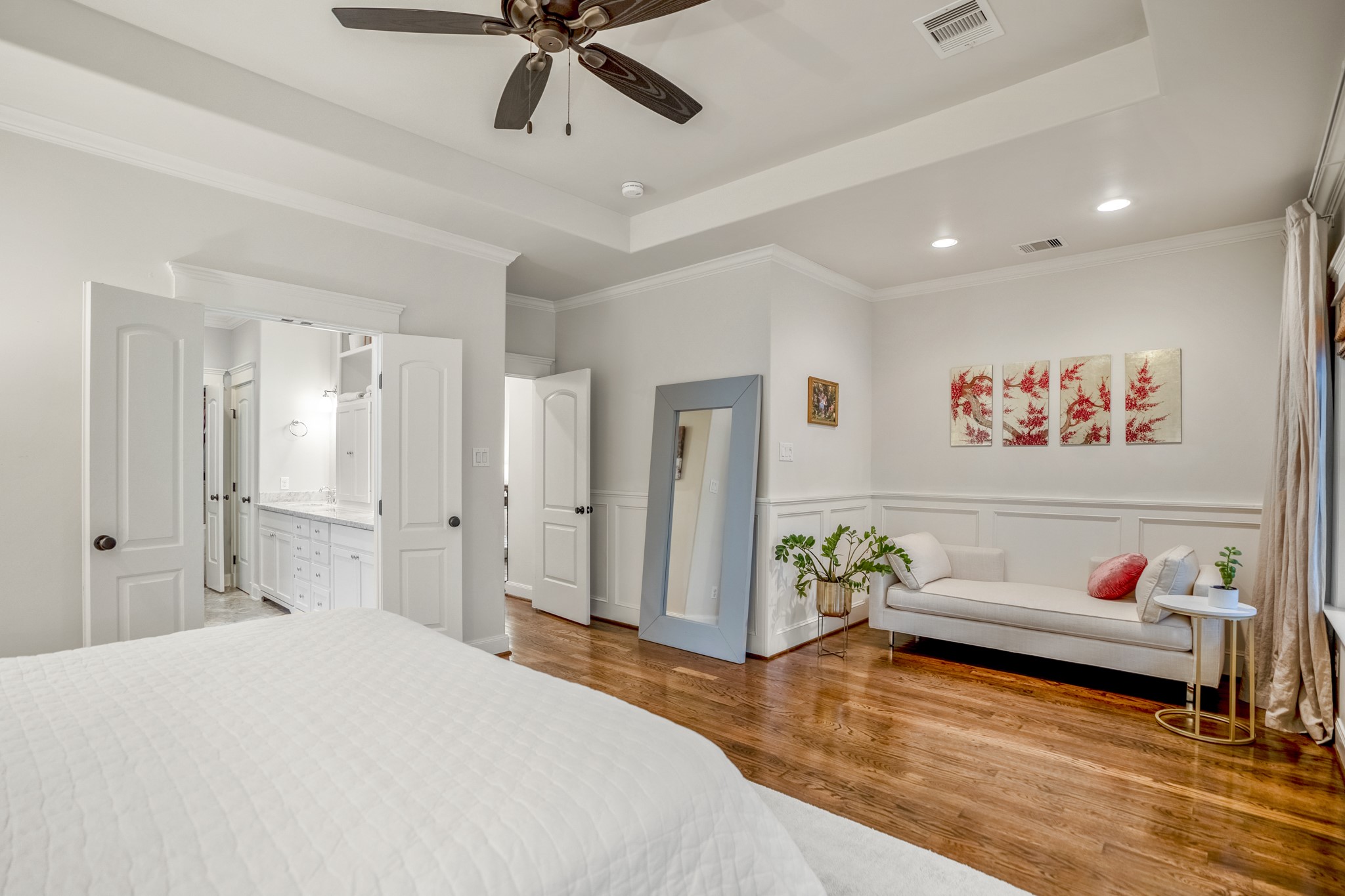 Across from the bed is a recessed area with custom wood paneling that's perfect for a chaise lounge for a reading nook.